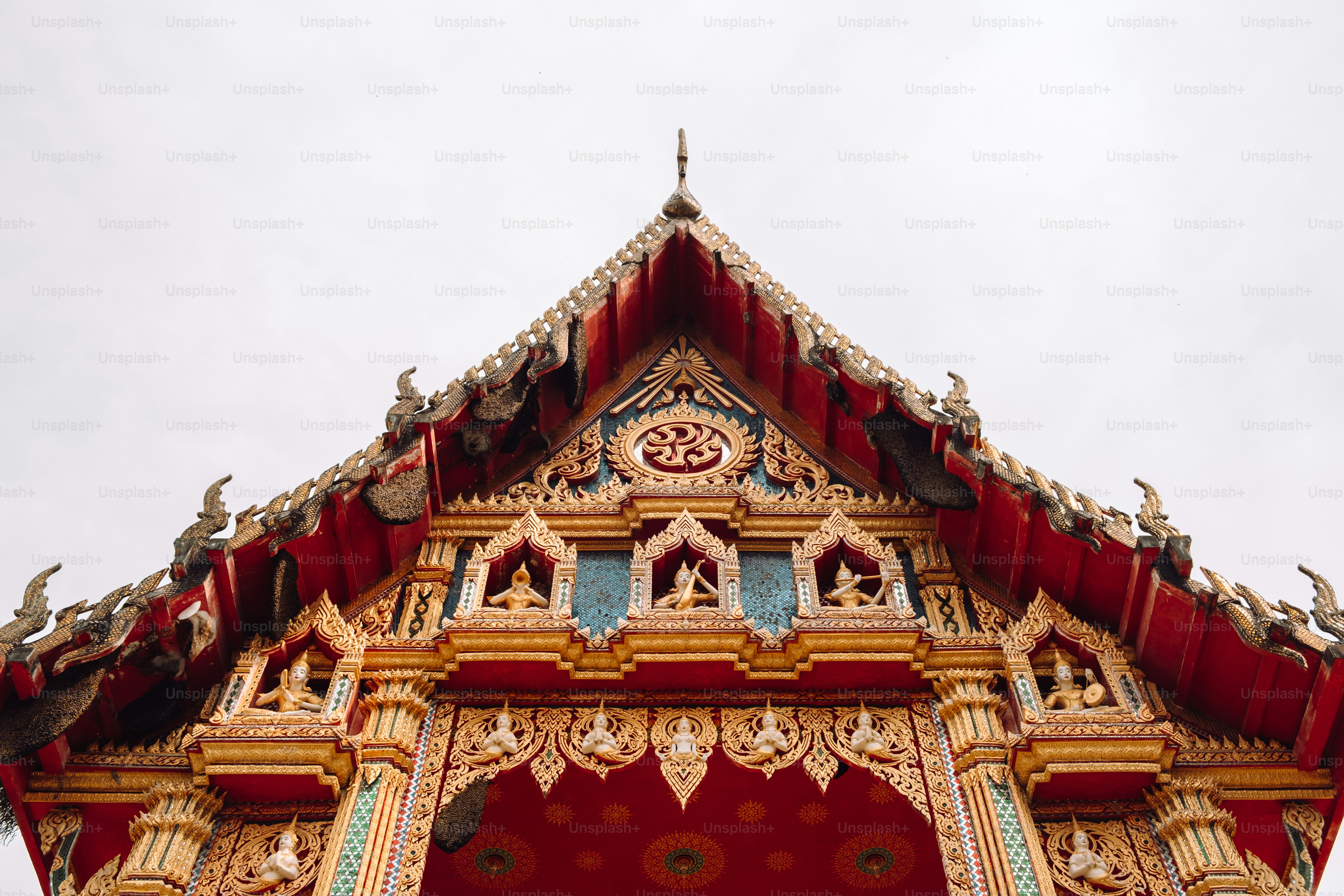 a red and gold building with a clock on it