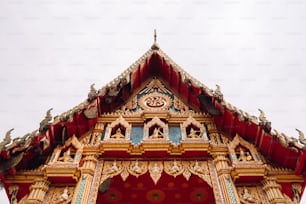 a red and gold building with a clock on it