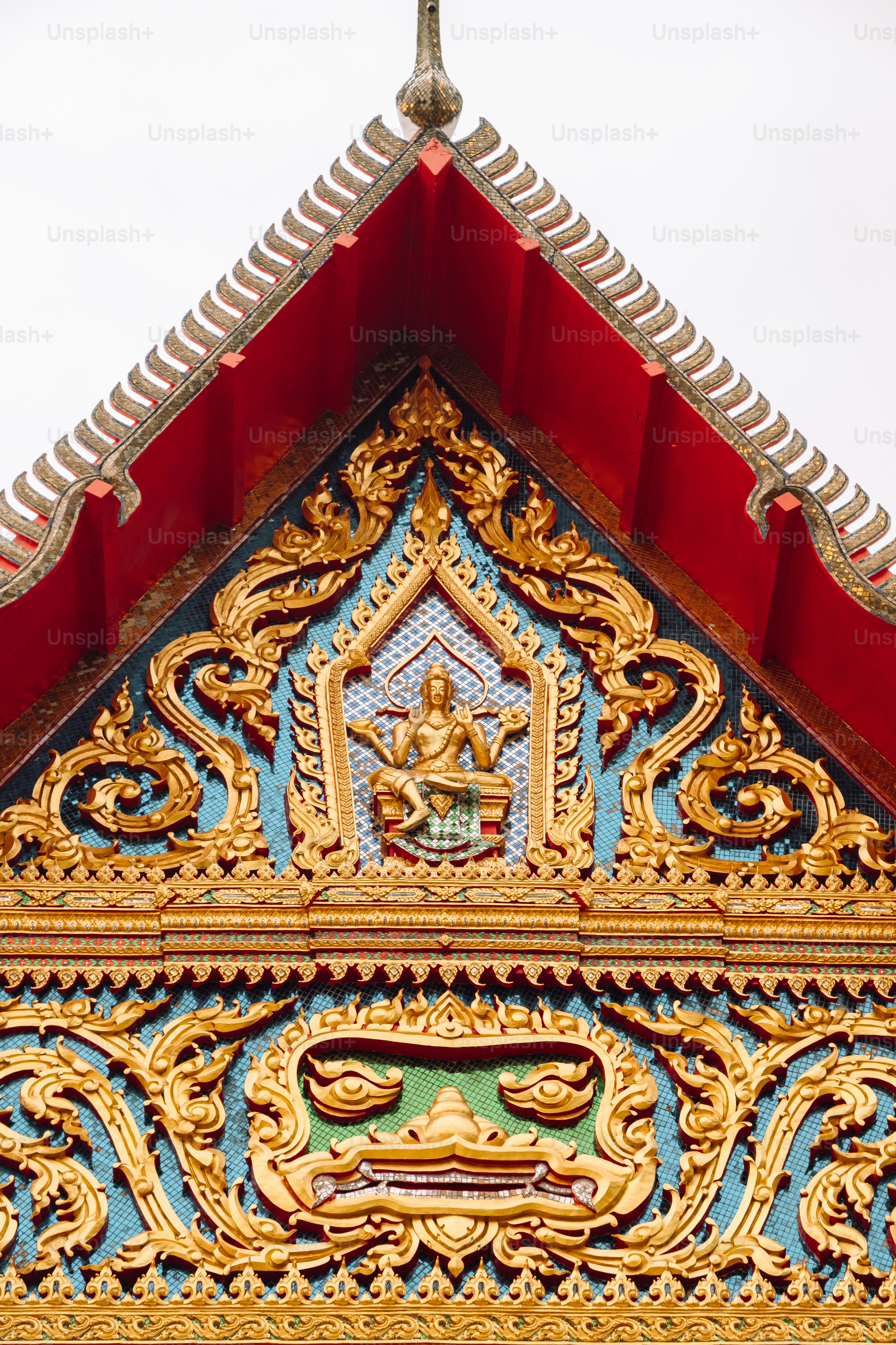 a gold and blue building with a cross on top of it