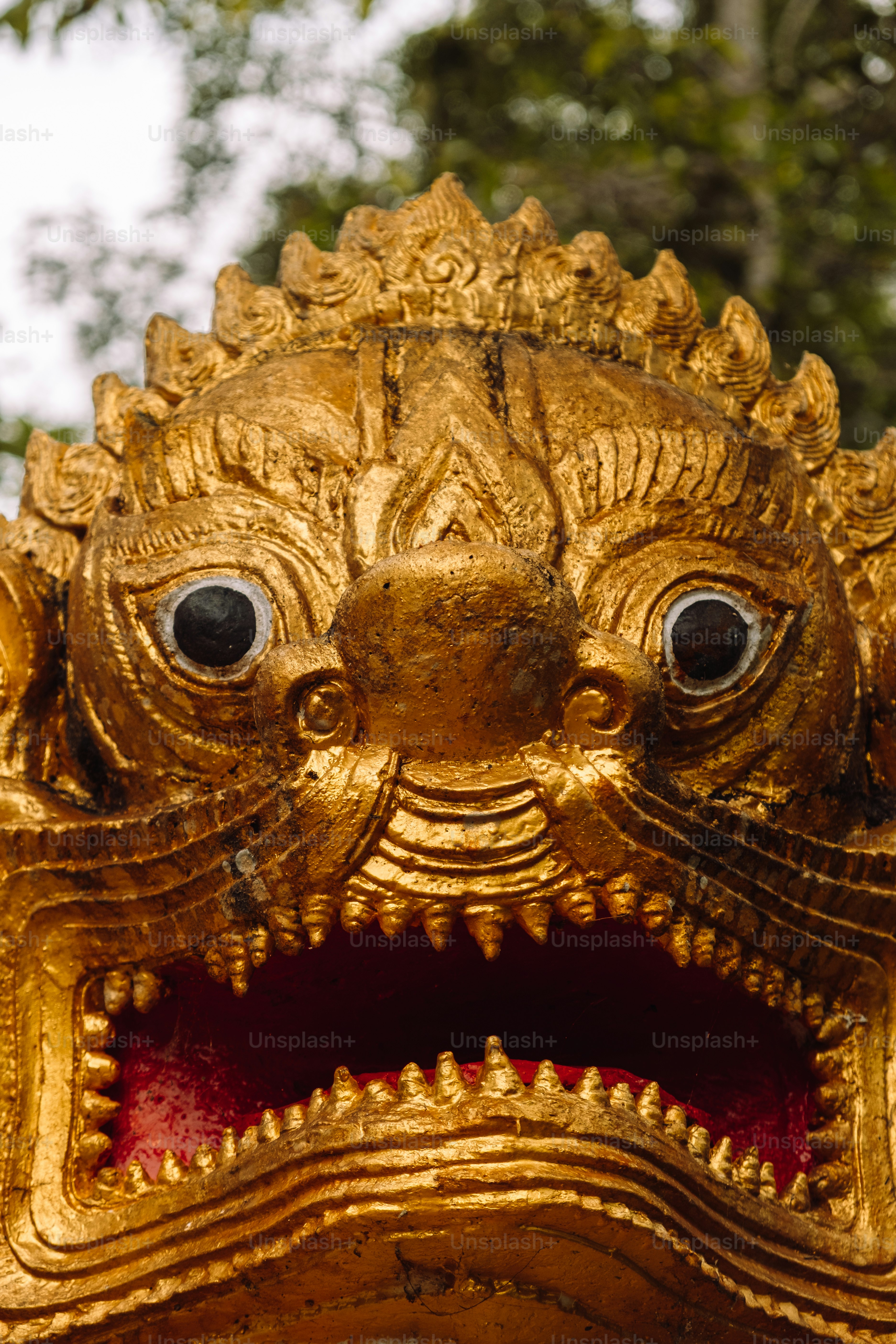 a close up of a gold lion statue