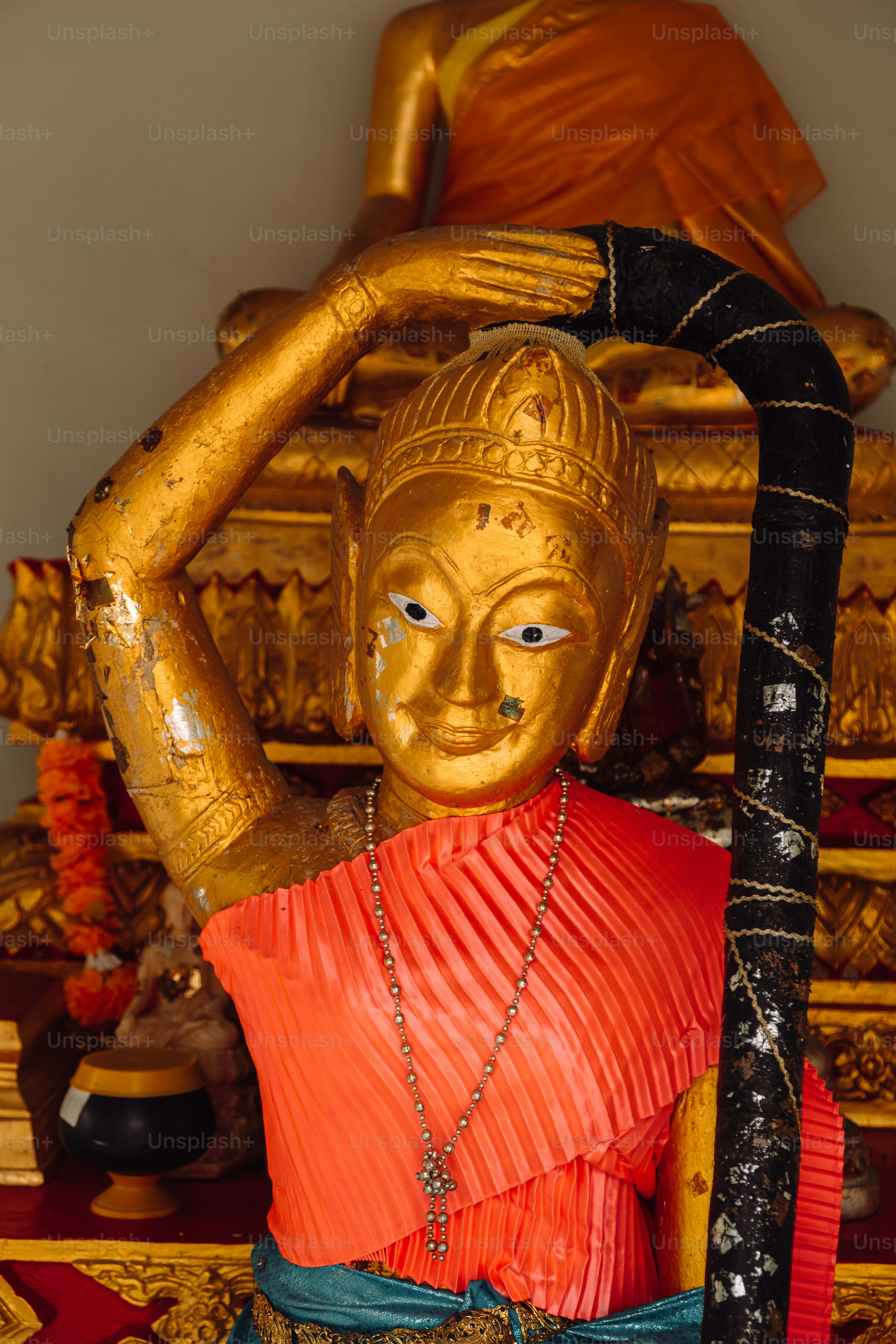 a statue of a person holding a stick