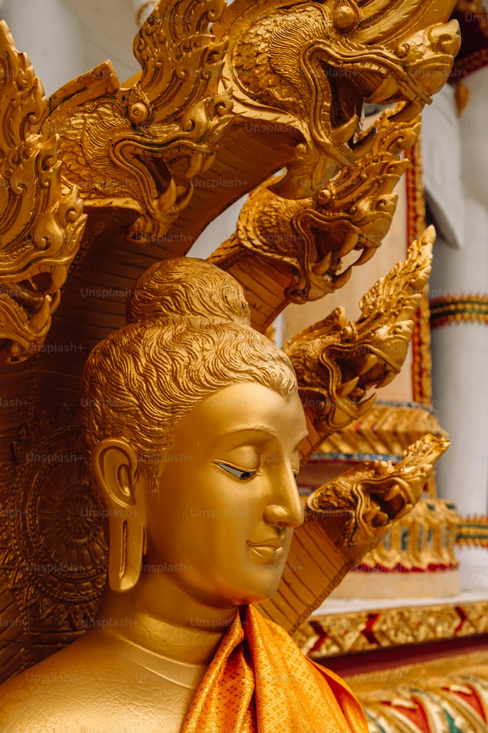 a golden buddha statue with a dragon on it's back