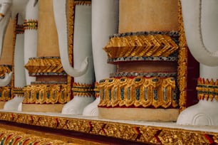 a row of gold and white elephants statues