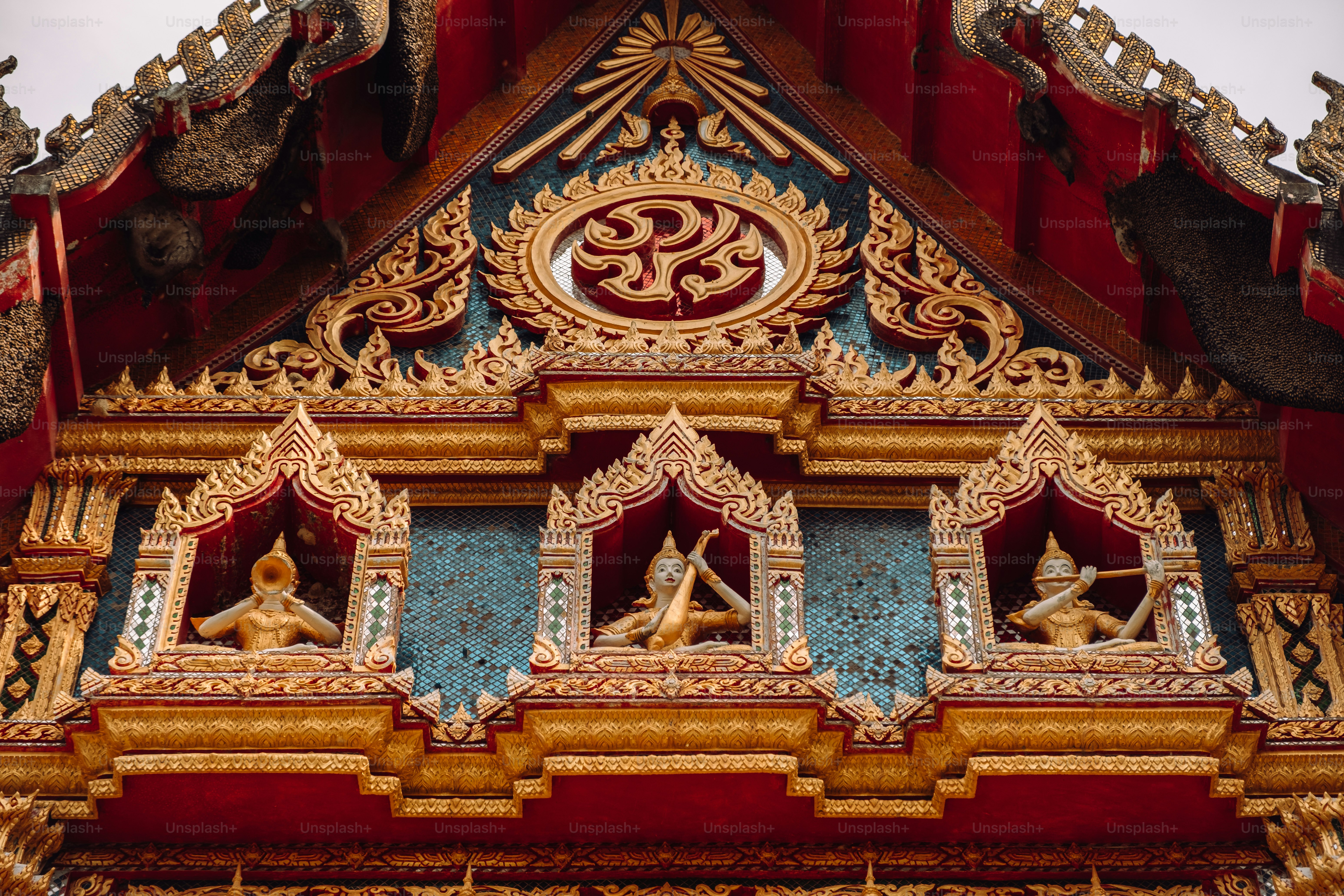 a close up of a building with statues on it