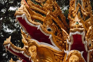 a close up of a gold and red statue