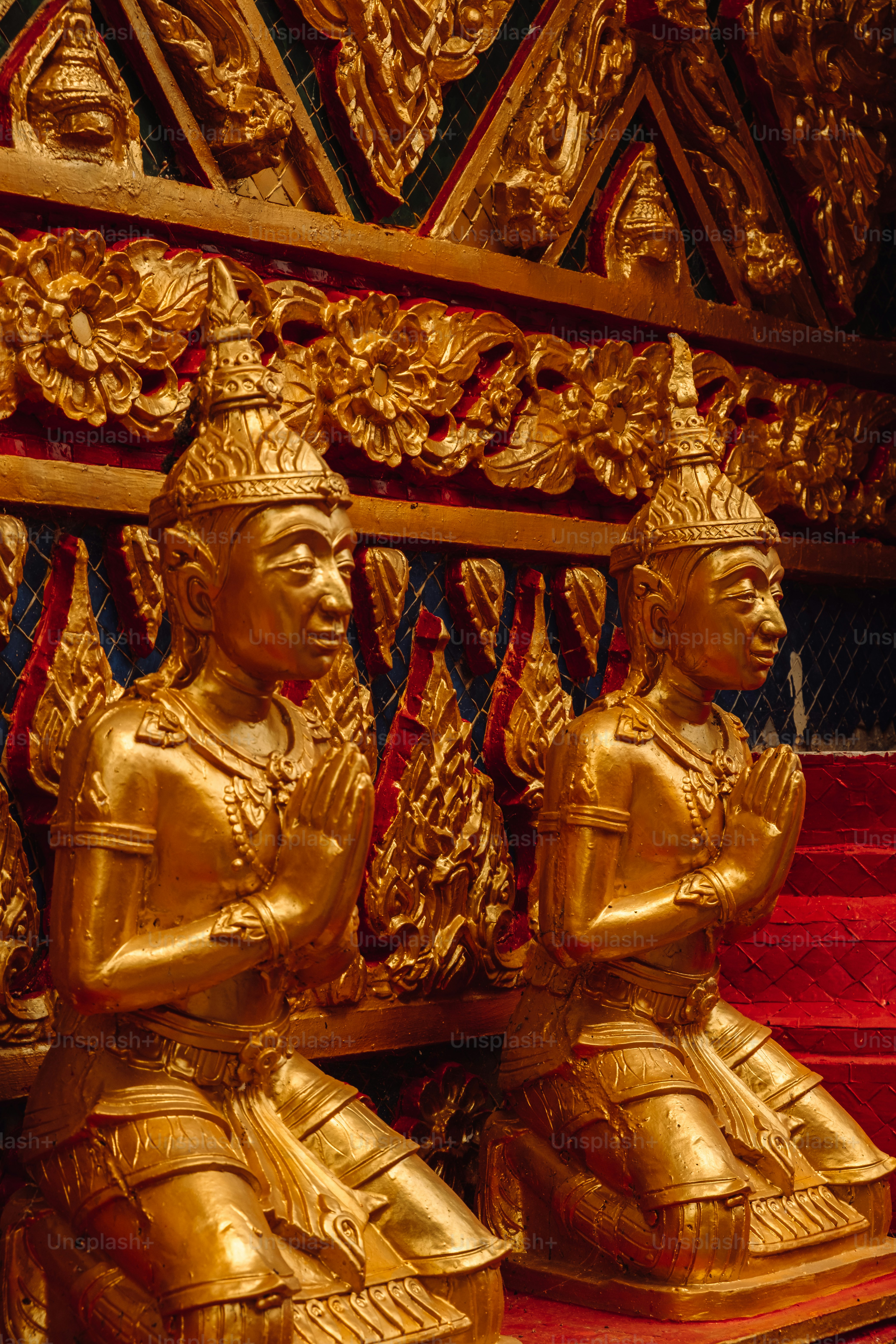 two golden statues sitting next to each other