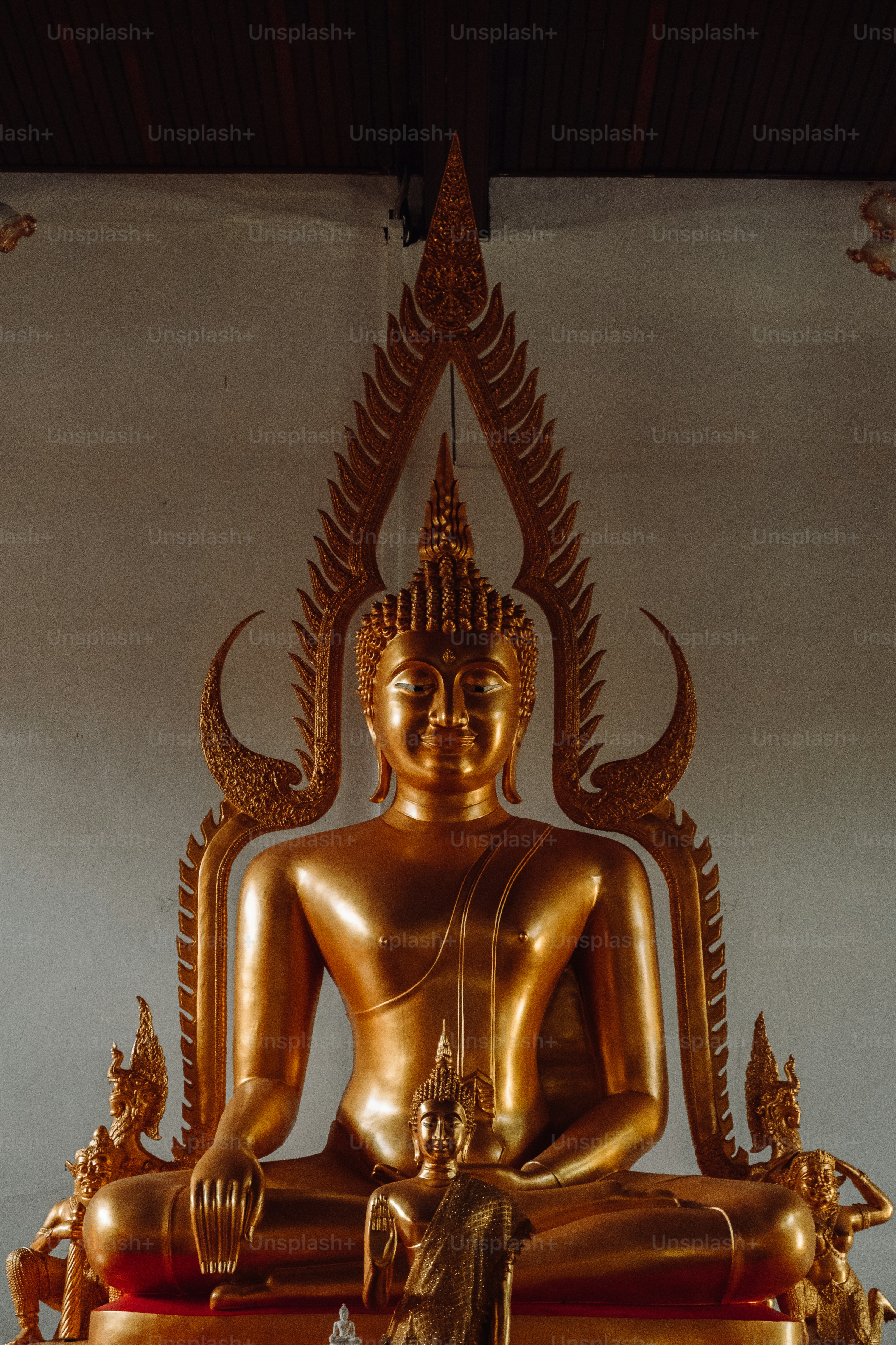 a golden buddha statue sitting on top of a table