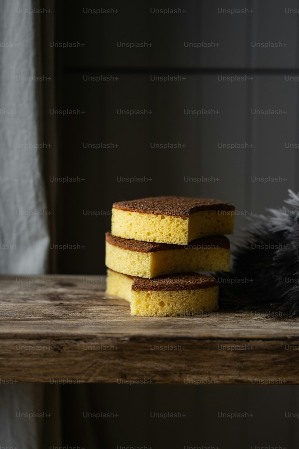 a stack of sponges sitting on top of a wooden table
