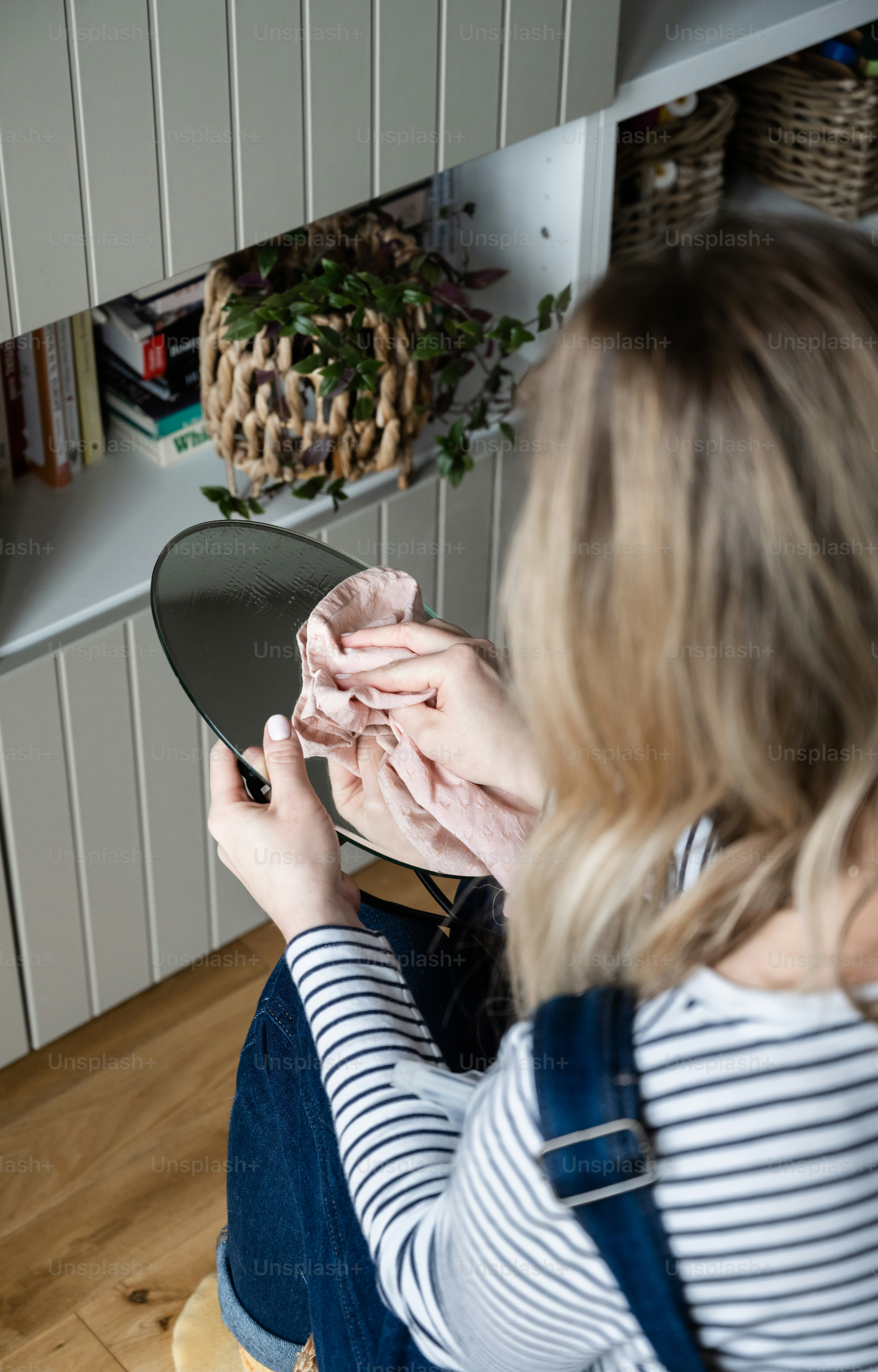a woman sitting on the floor holding a piece of cloth