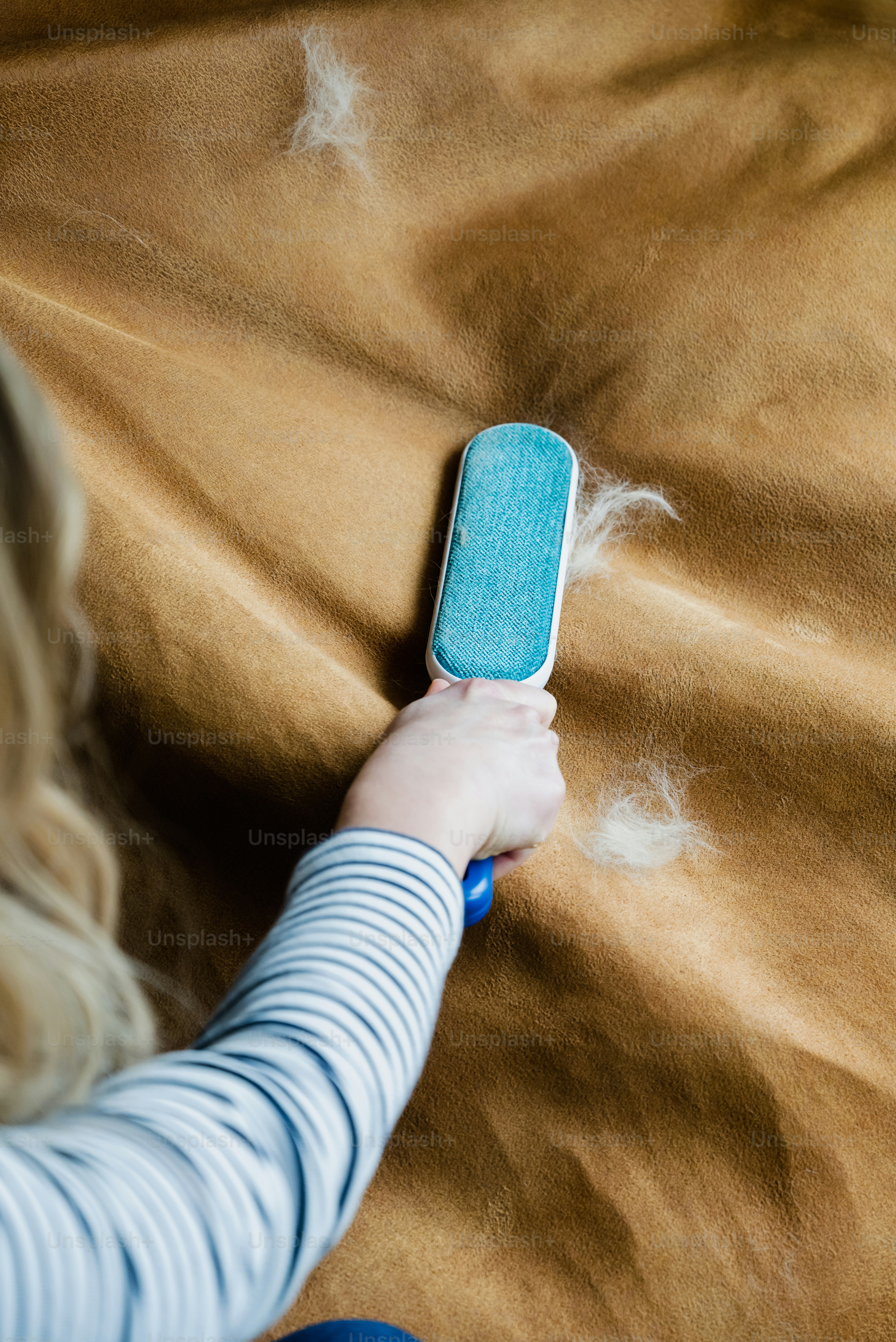 a woman laying on a bed holding a cell phone