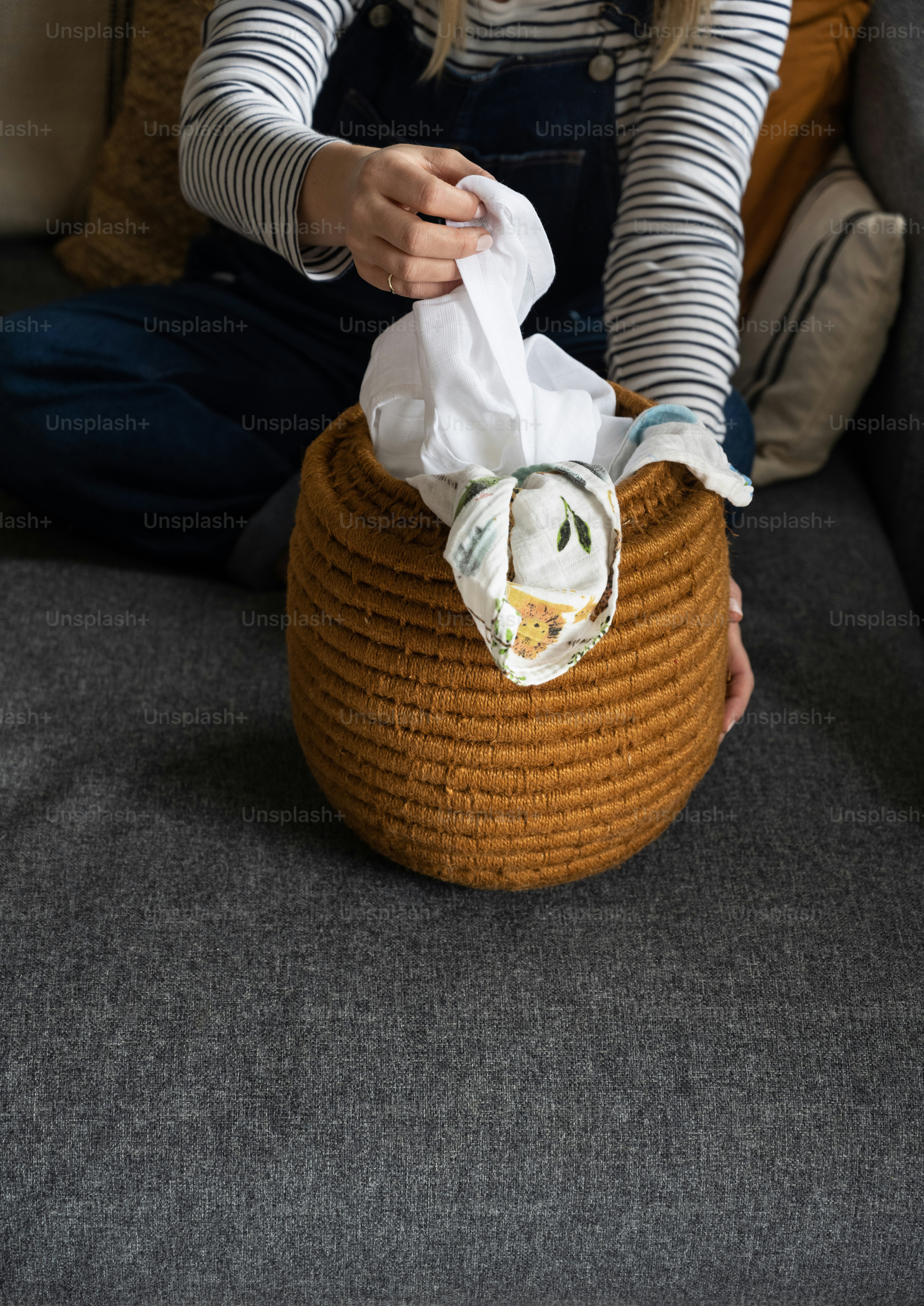 a woman sitting on a couch with a basket