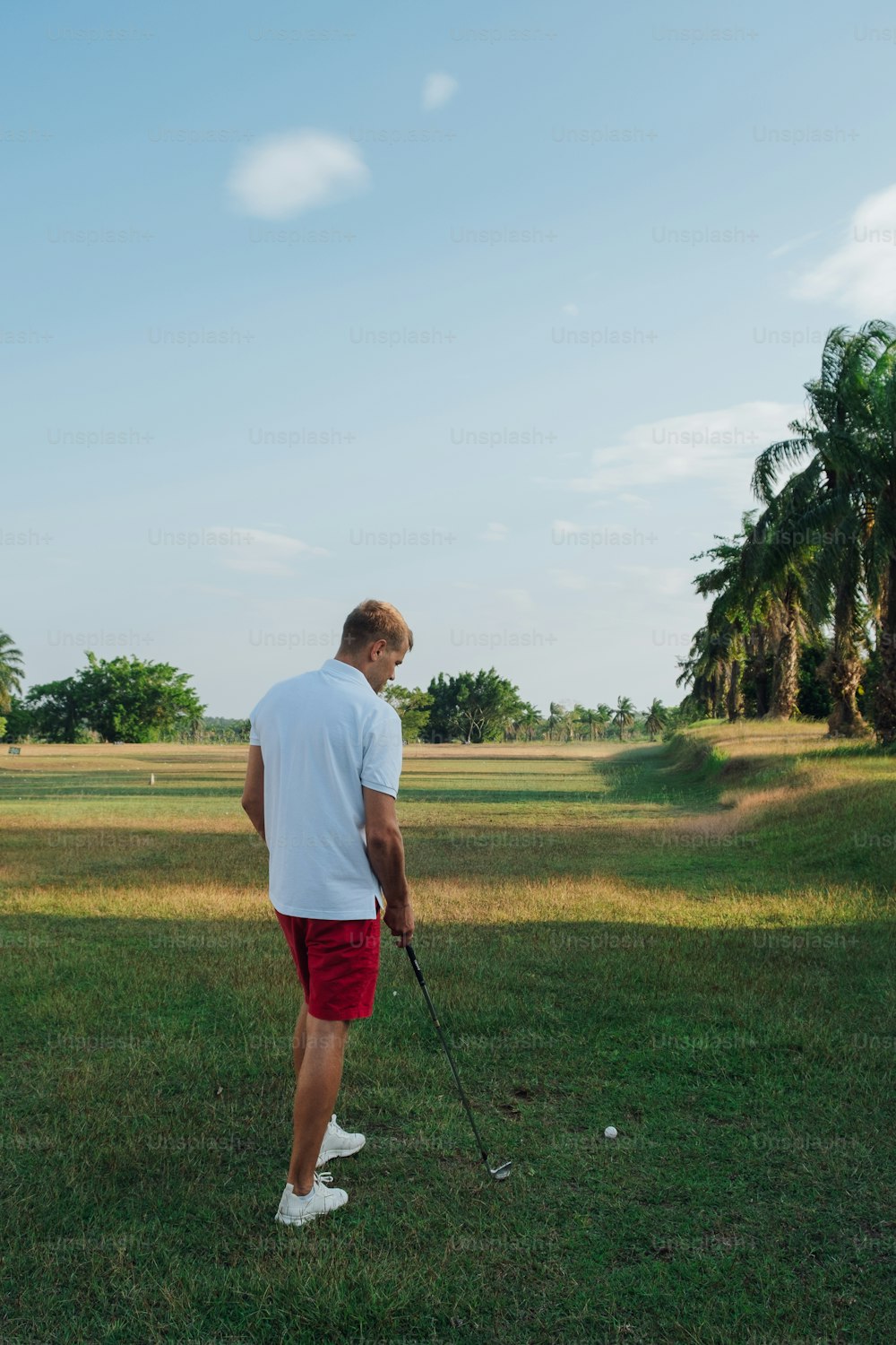 a man standing on top of a lush green field