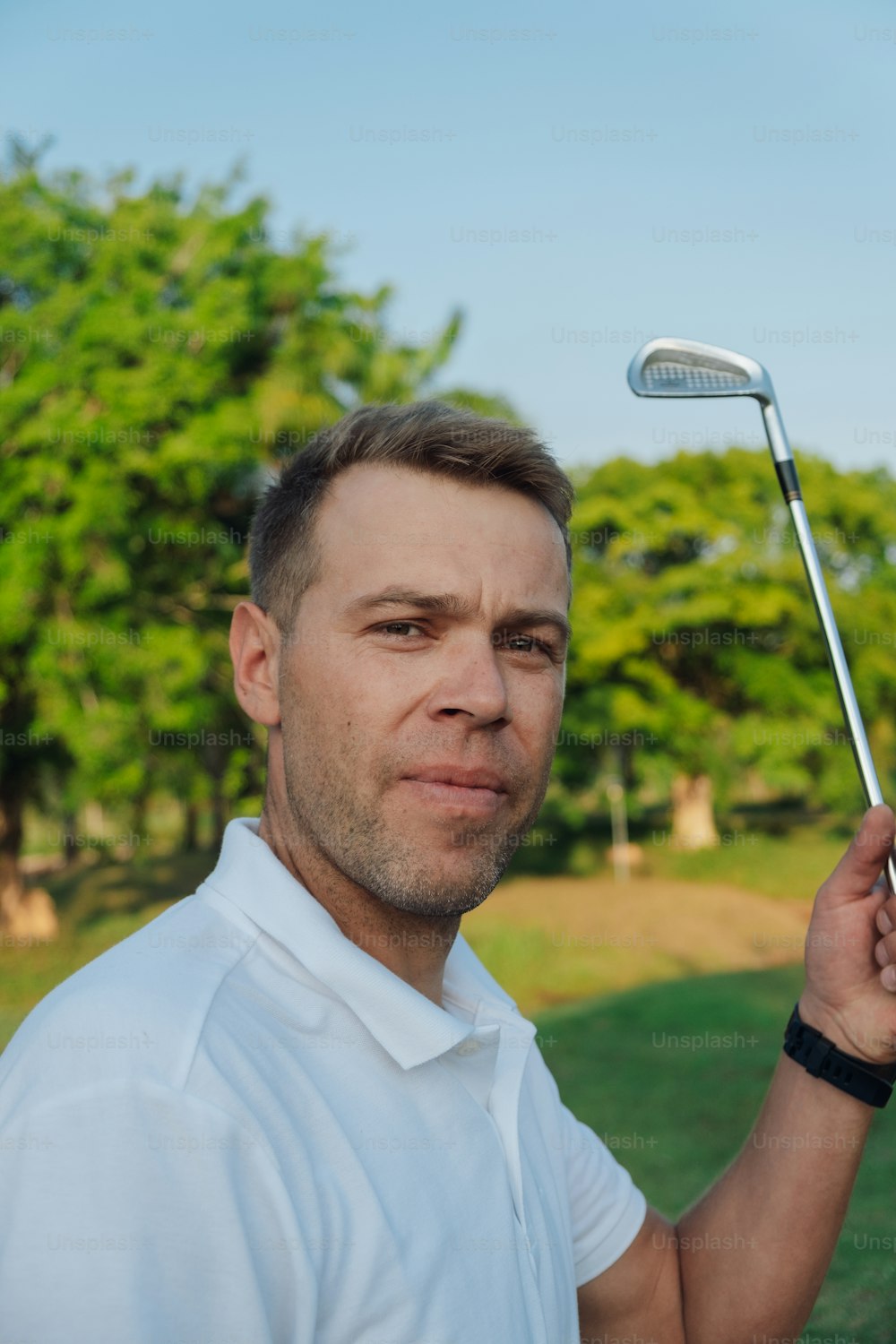 a man holding a golf club in his hand