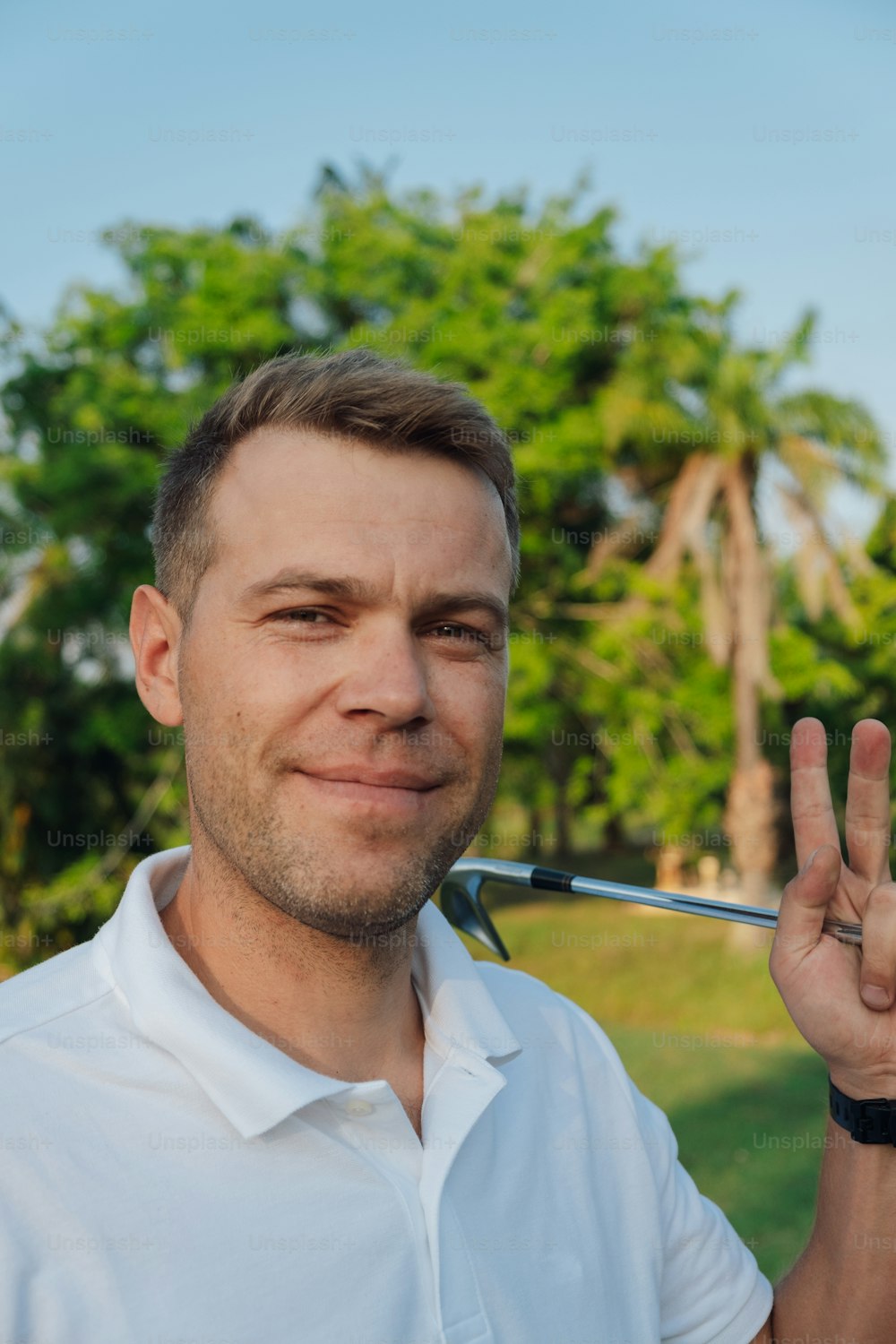 a man holding a golf club in his hand