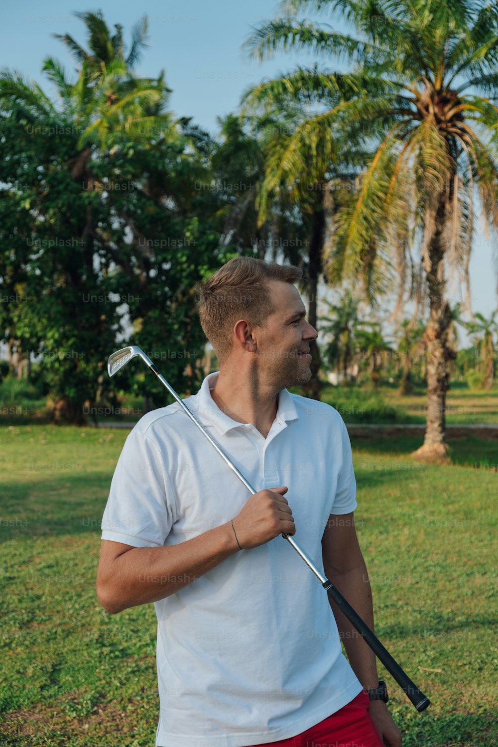 a man holding a golf club in his hand