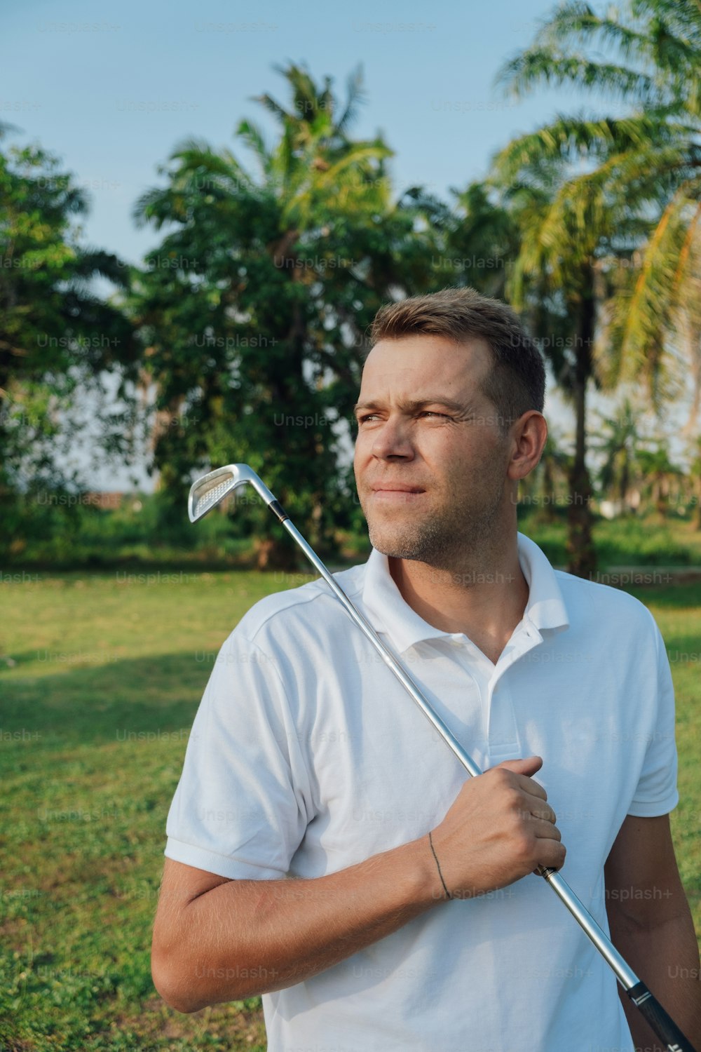 a man holding a golf club in his hand