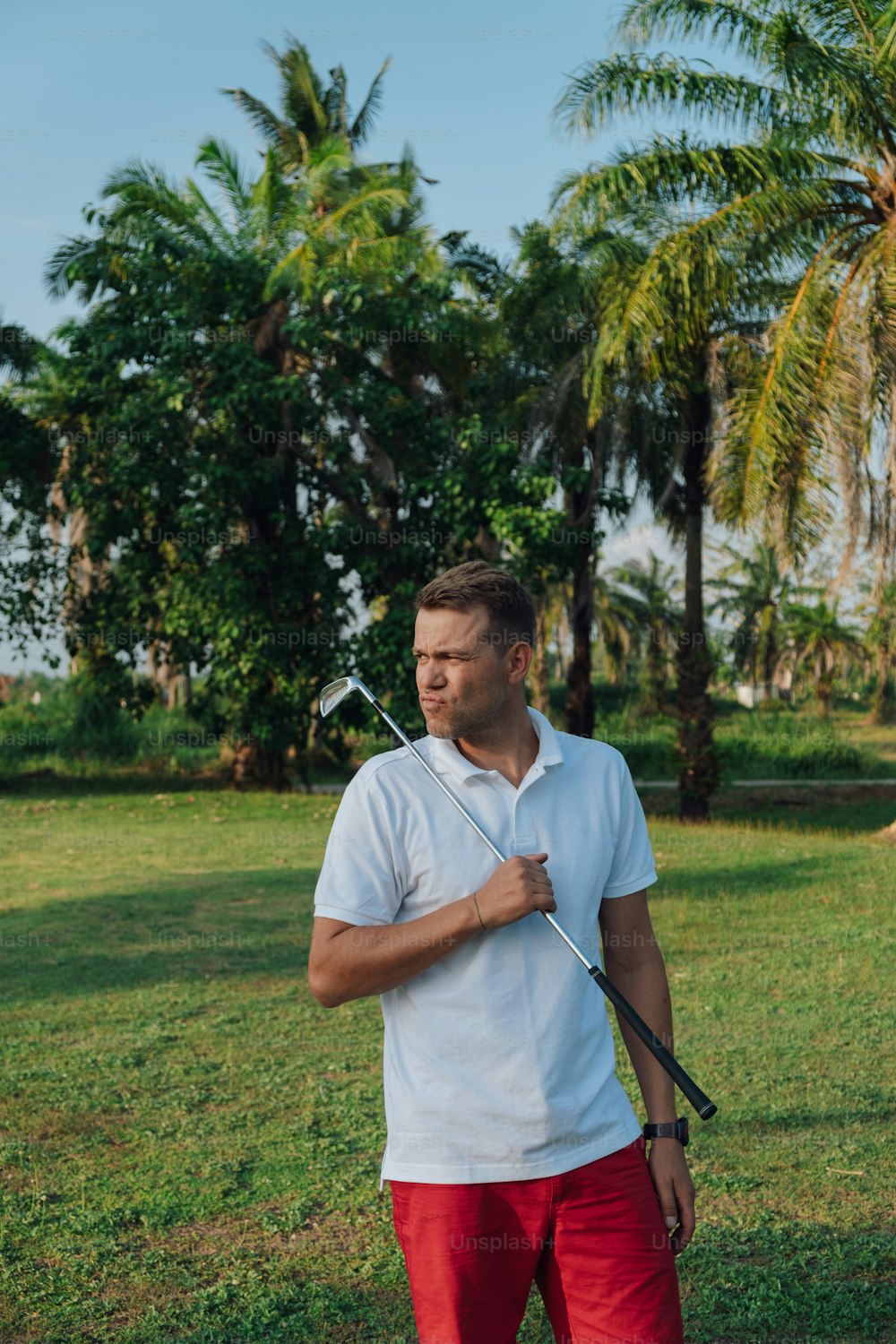 a man holding a golf club in his hands