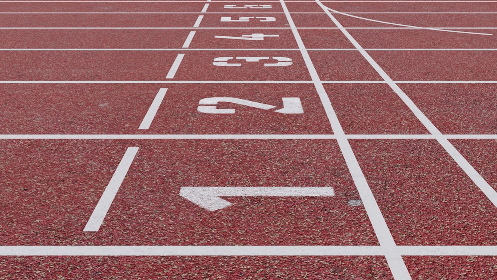 a red running track with white numbers on it