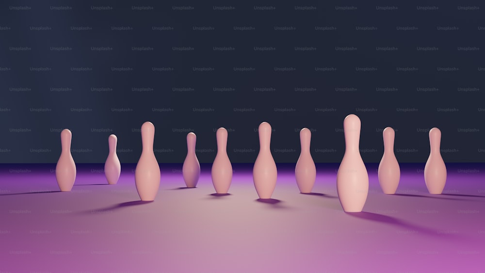 a group of pink bowling pins sitting on top of a purple floor