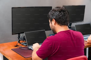 a man sitting at a desk working on a computer