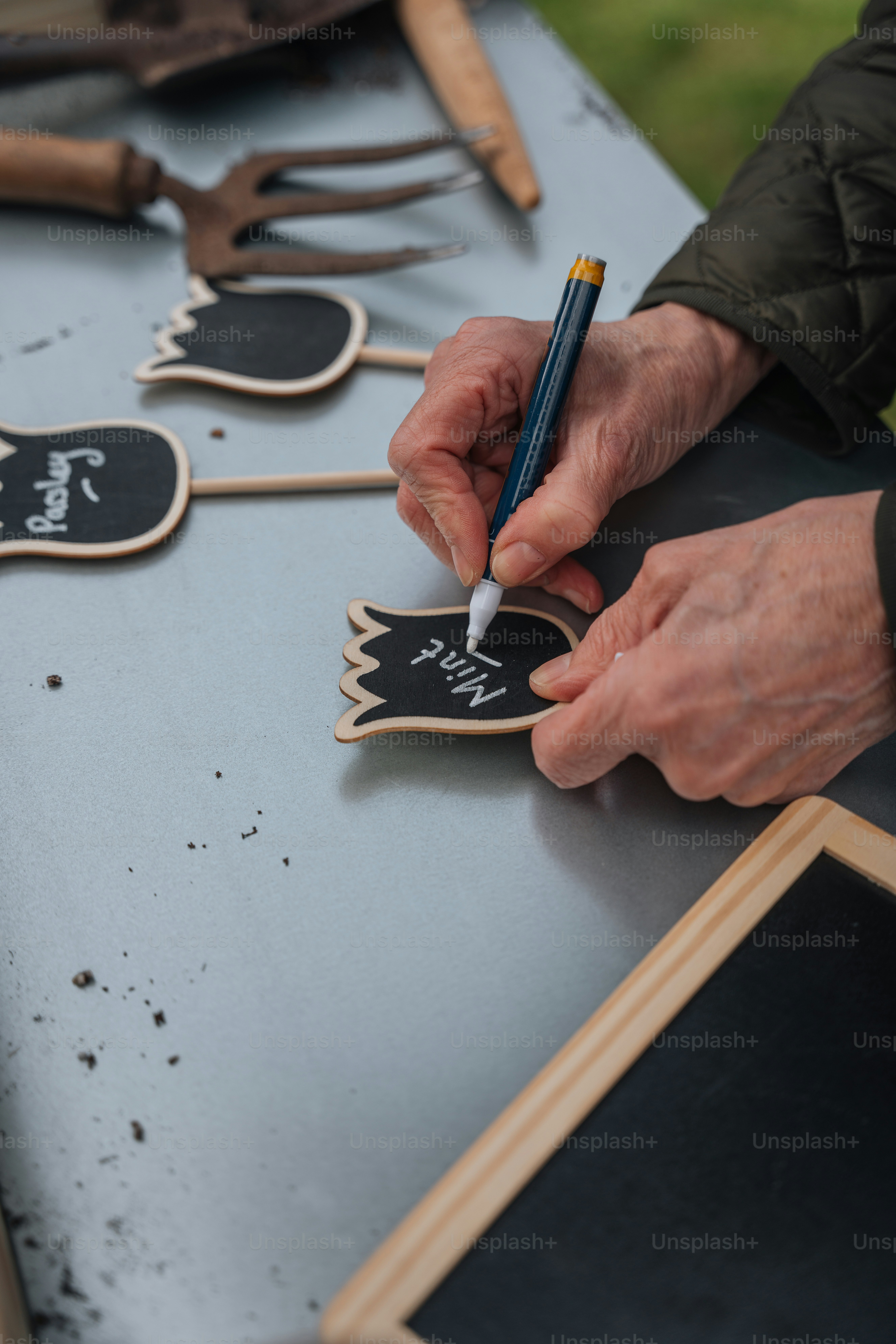 a person writing on a chalkboard with a marker