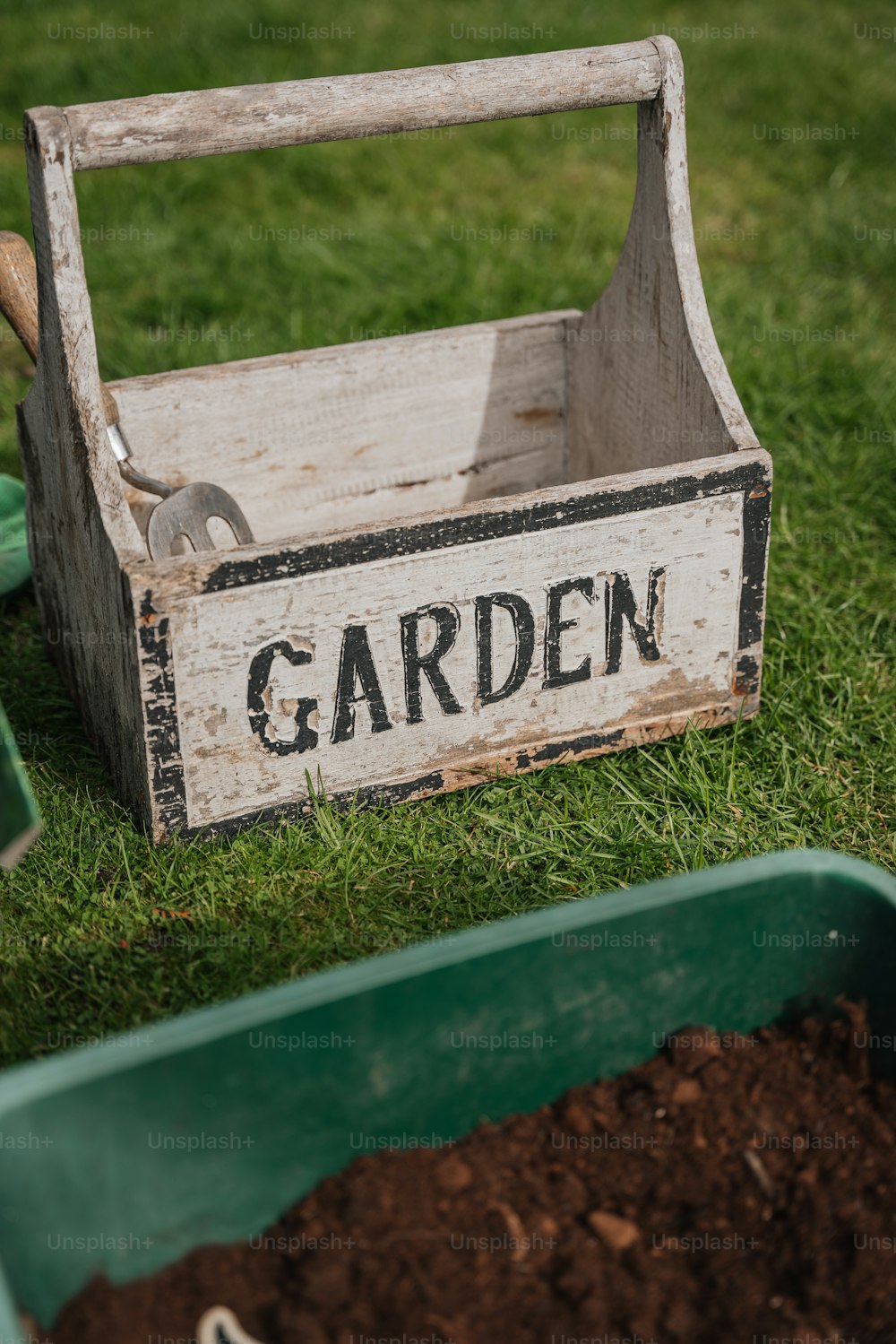 a garden box with a shovel and a shovel in it