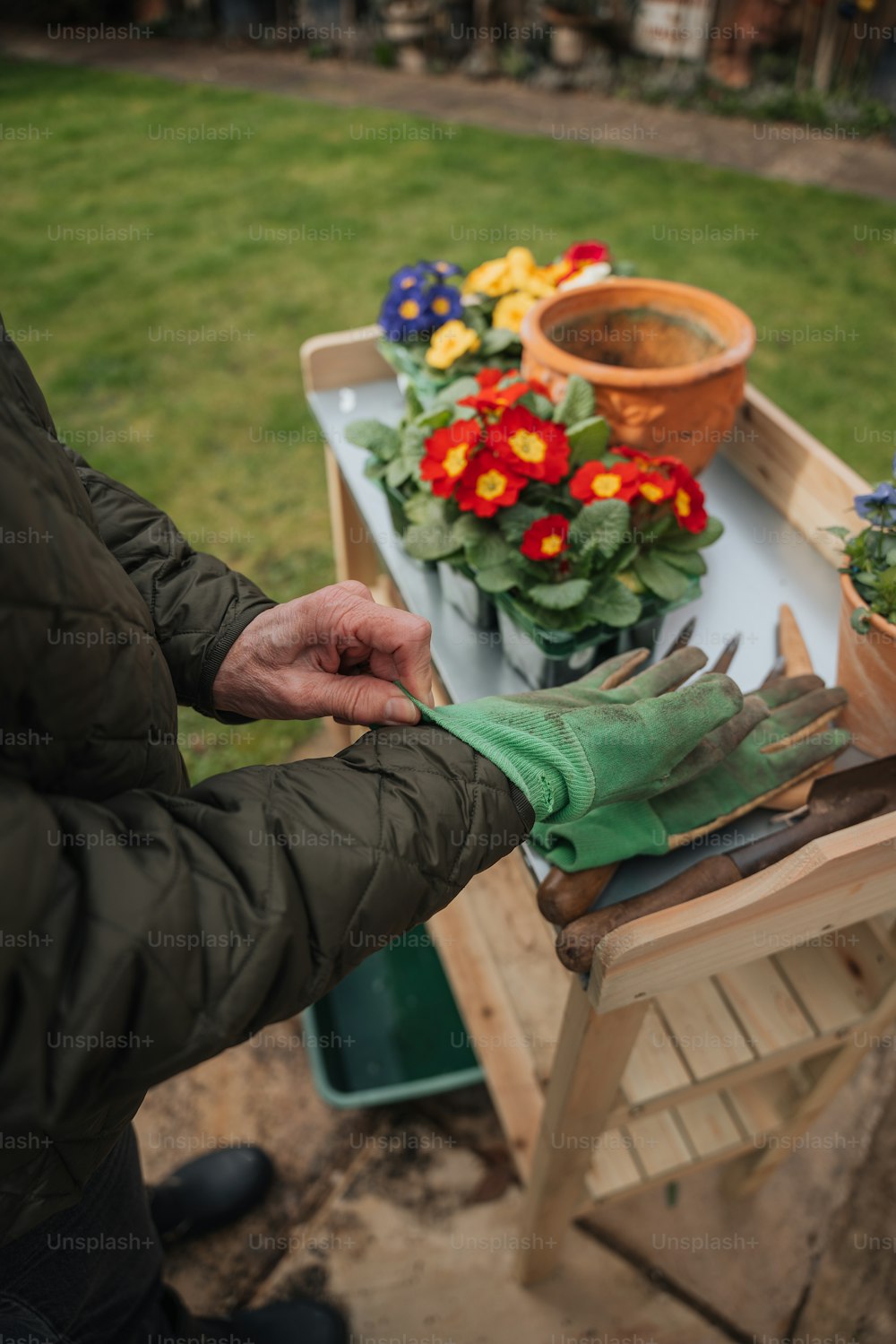 a person wearing gardening gloves and gardening gloves
