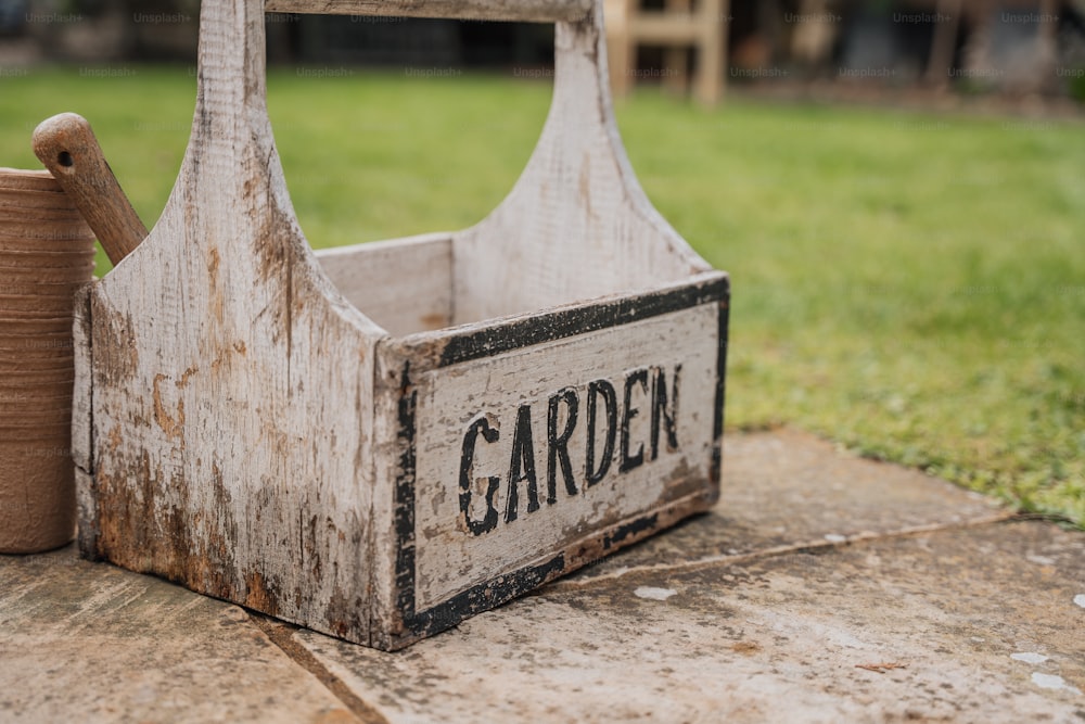 a wooden garden tool with a spool of thread next to it