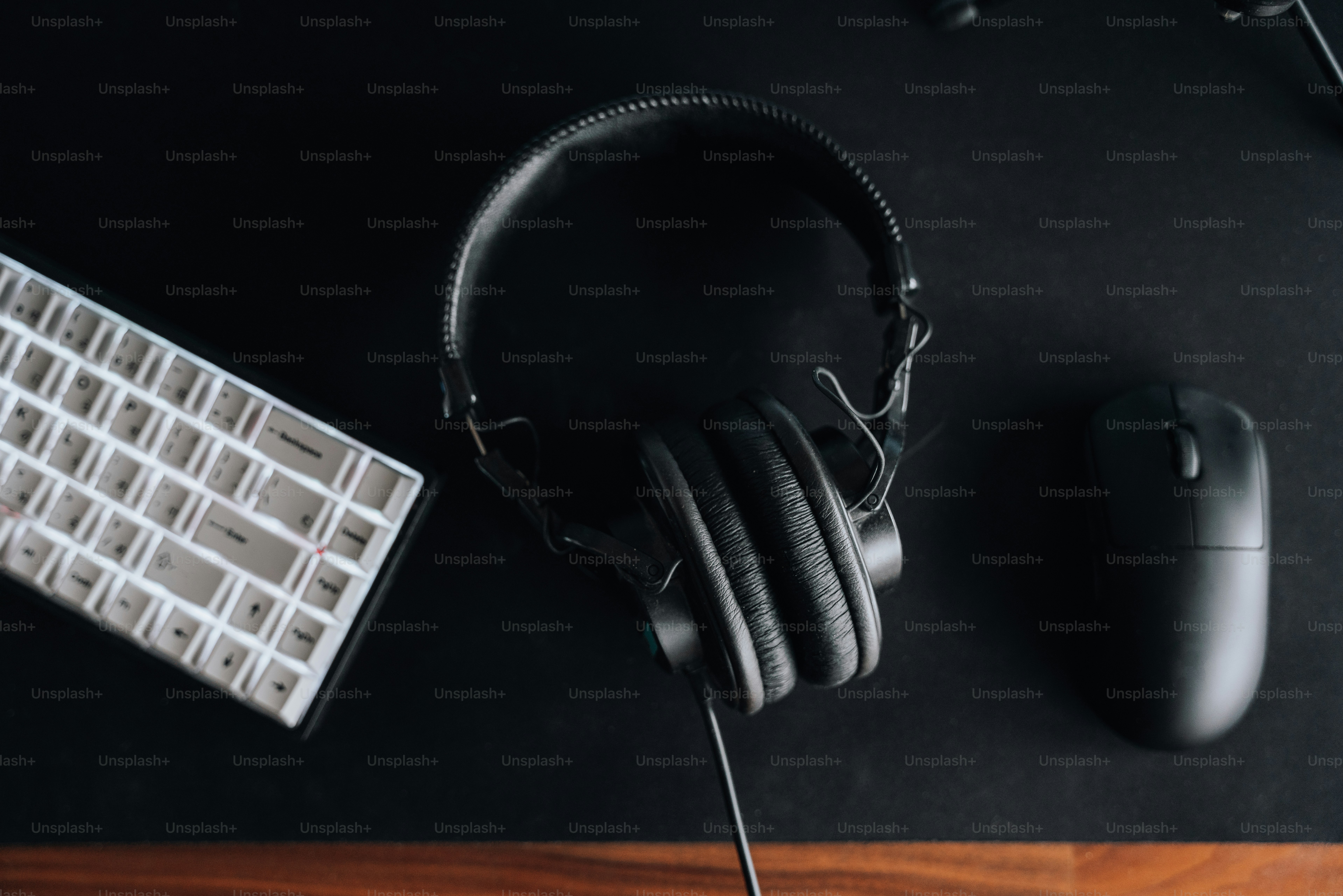 a pair of headphones sitting next to a keyboard