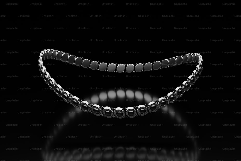 a black and white photo of a bracelet