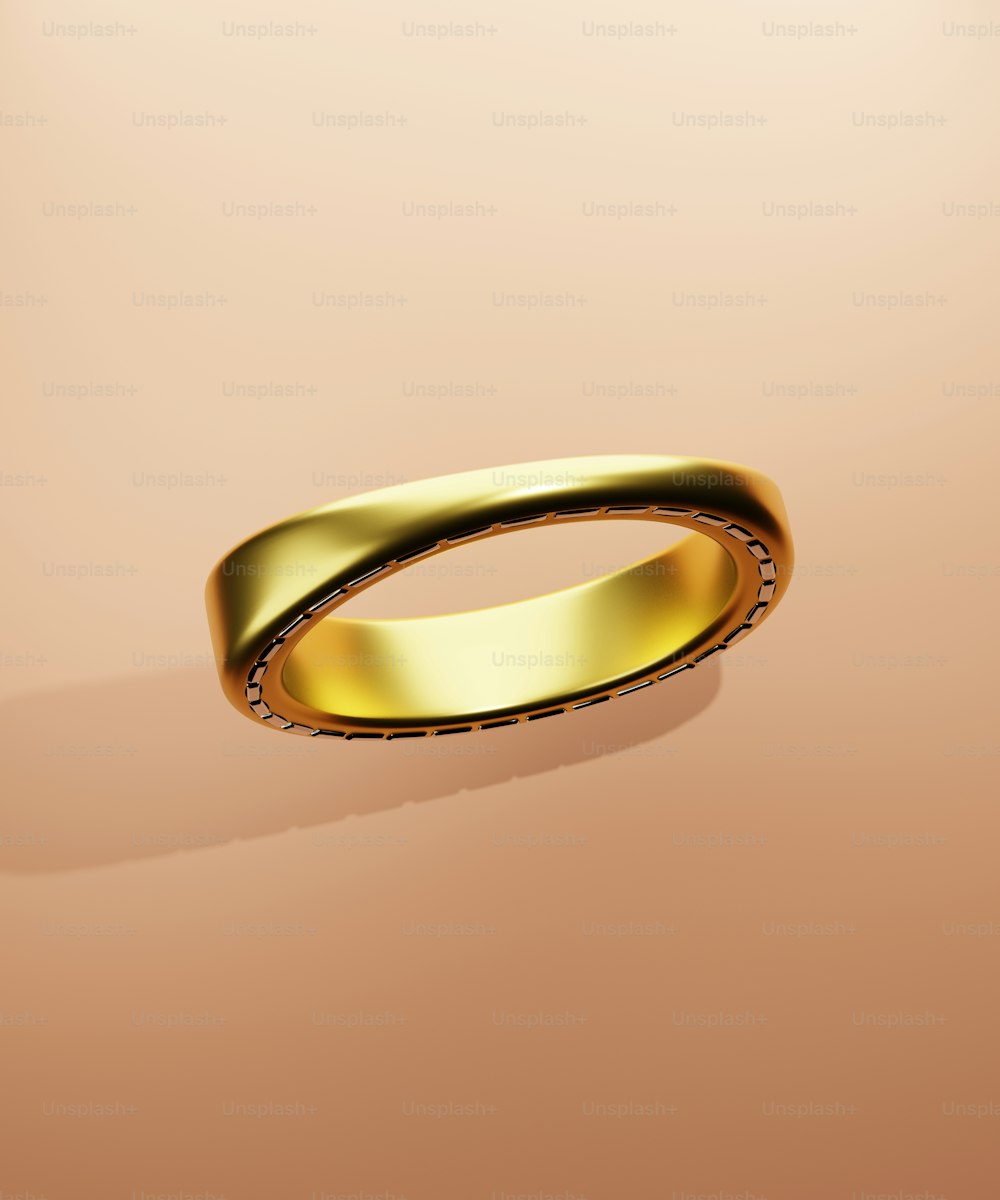 um anel de ouro em um fundo cor-de-rosa