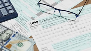 a pair of glasses sitting on top of a tax form