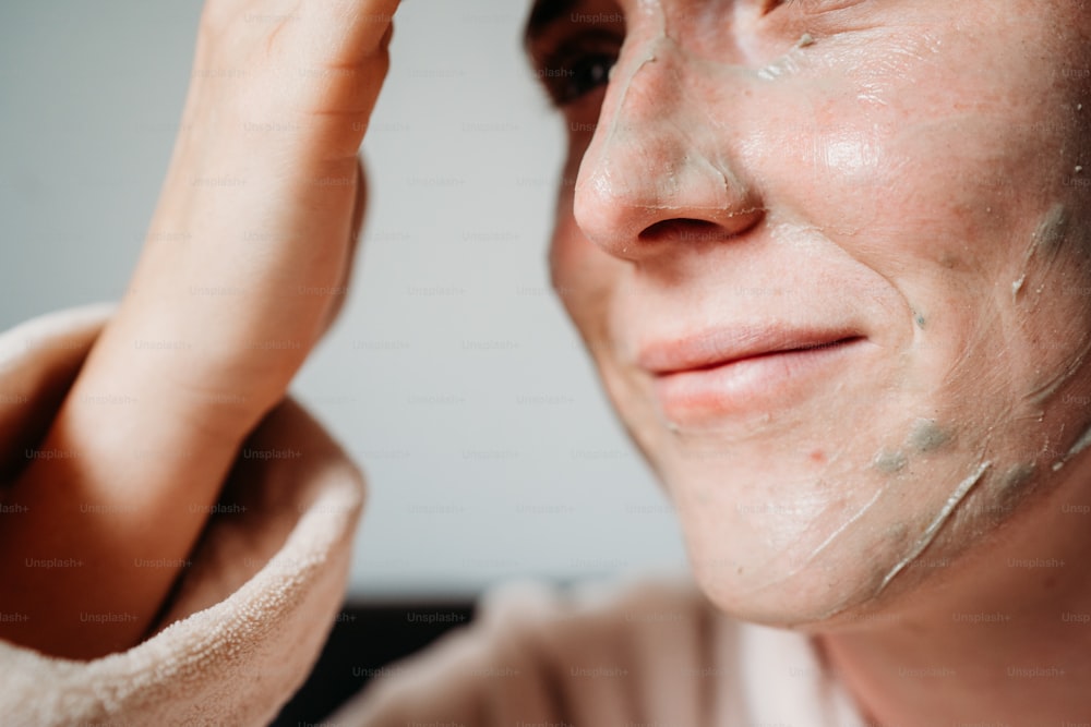 a close up of a person shaving their face