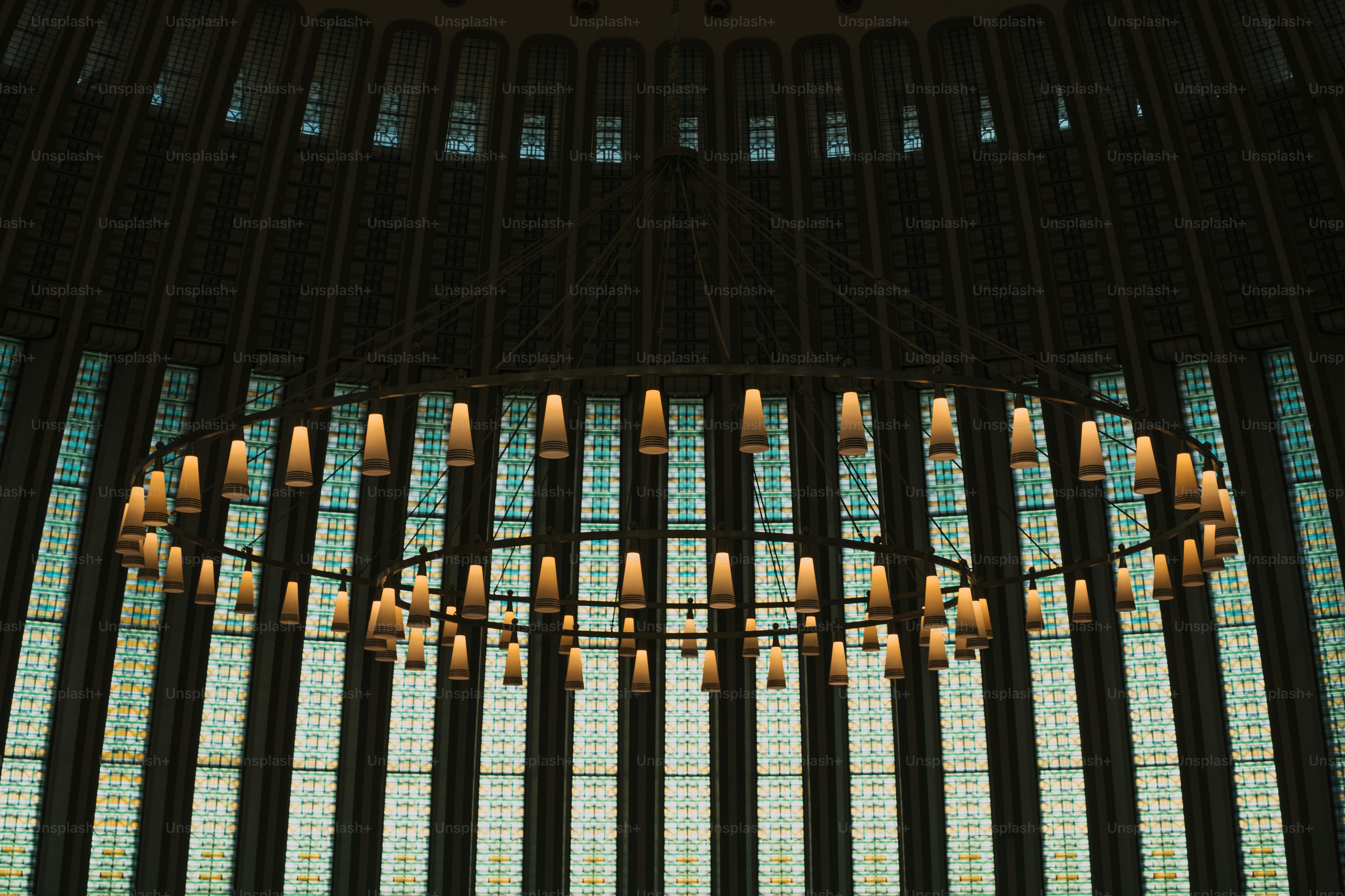 a chandelier in front of a large stained glass window
