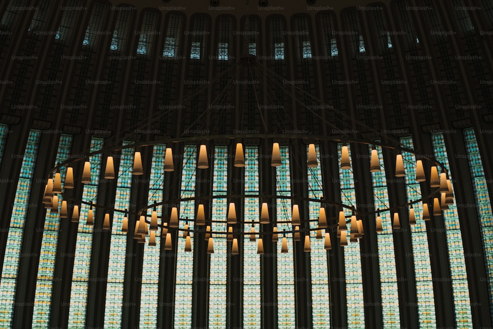 a chandelier in front of a large stained glass window