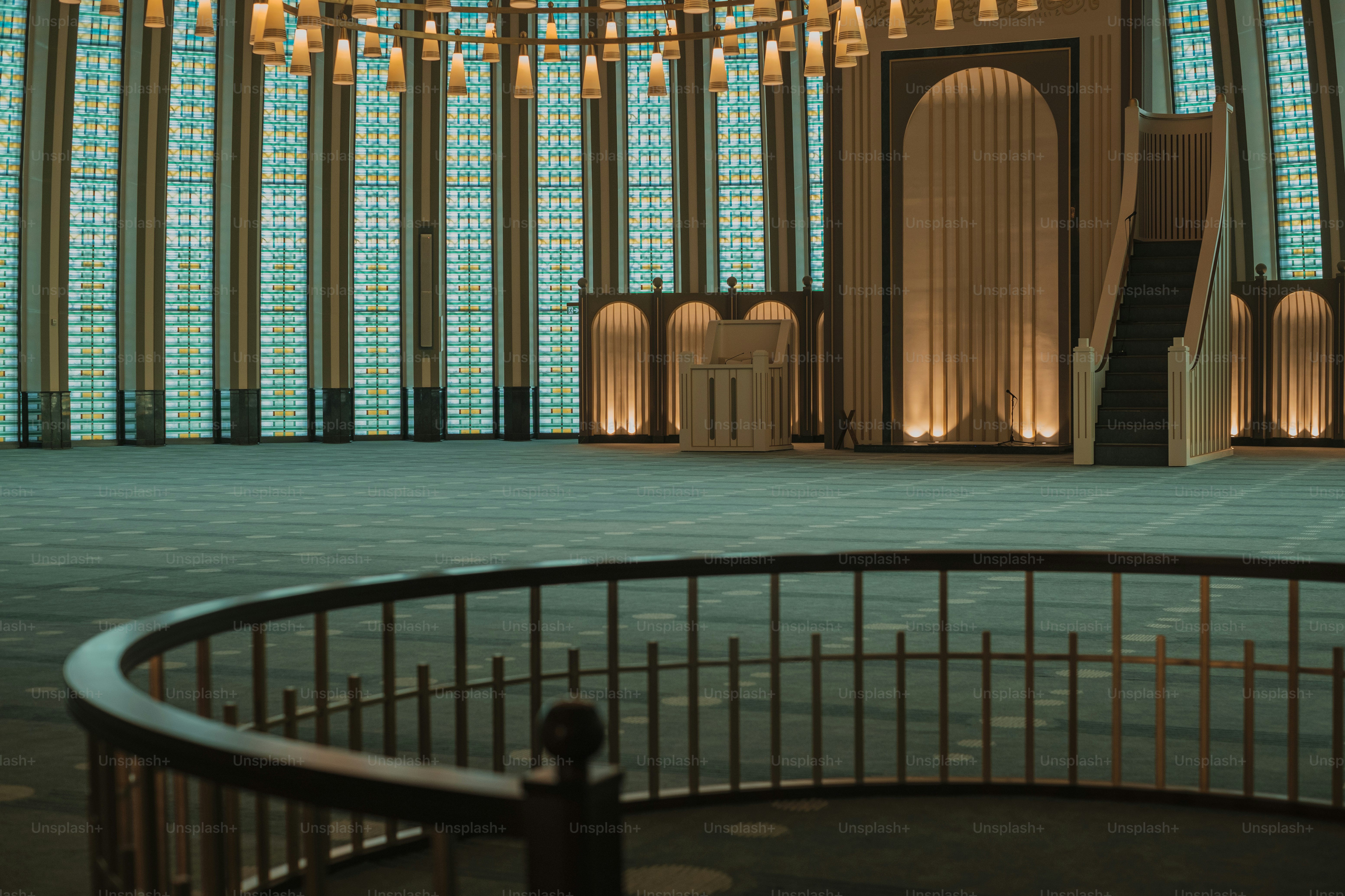 a large room with a chandelier and a circular staircase
