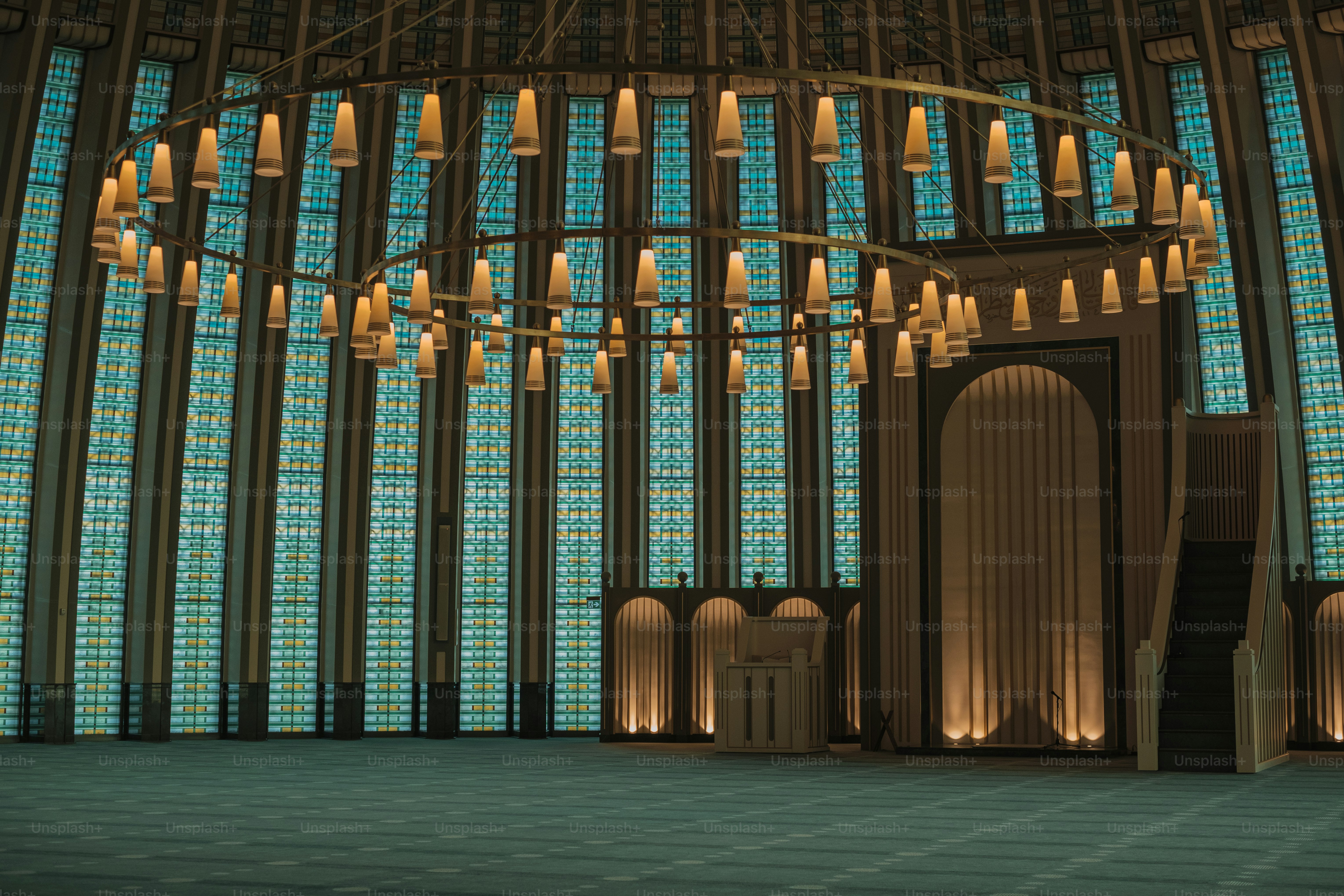 a large chandelier in a large room with a lot of windows