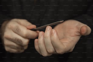 a person holding a cell phone in their hands
