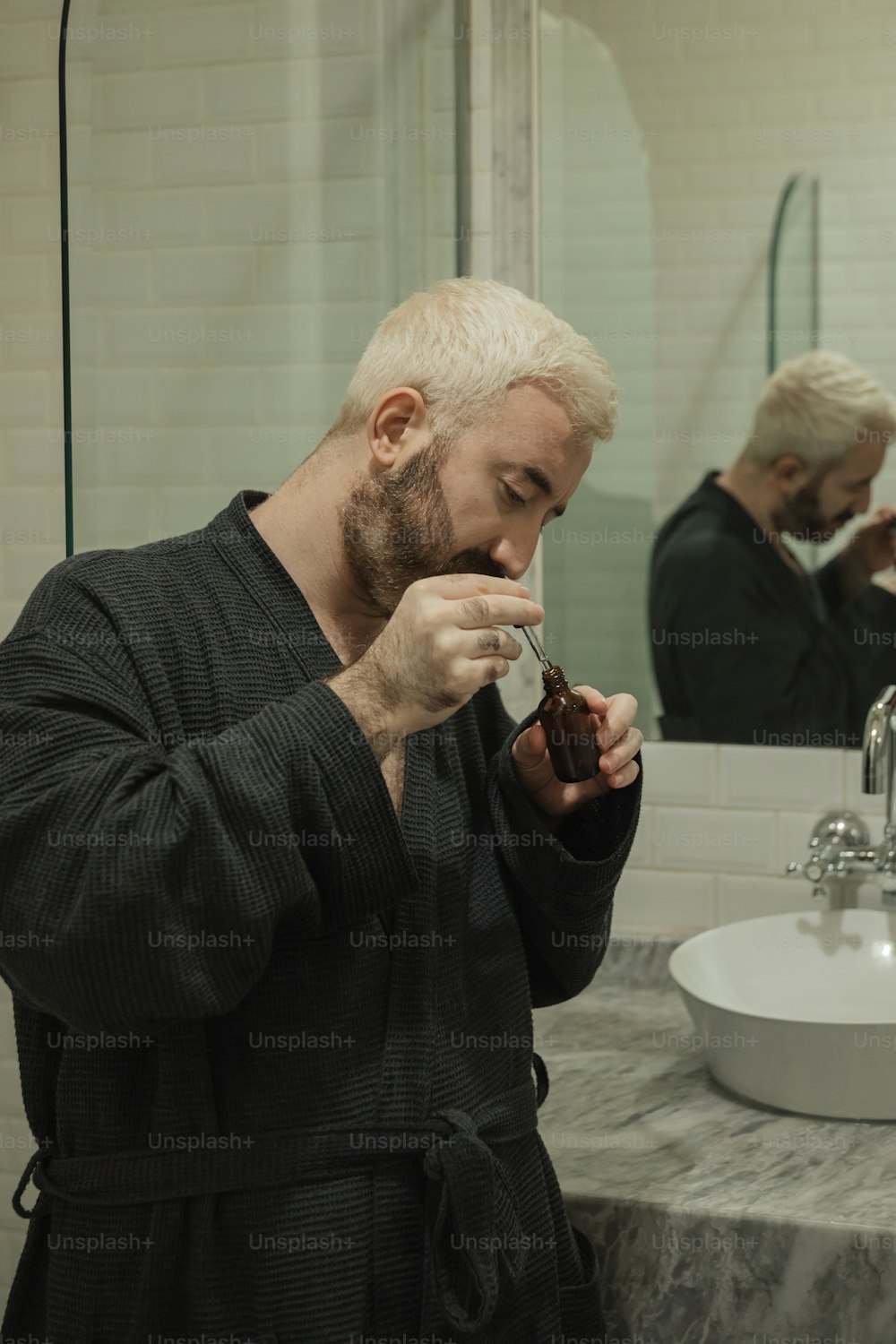 a man in a bathrobe brushing his teeth