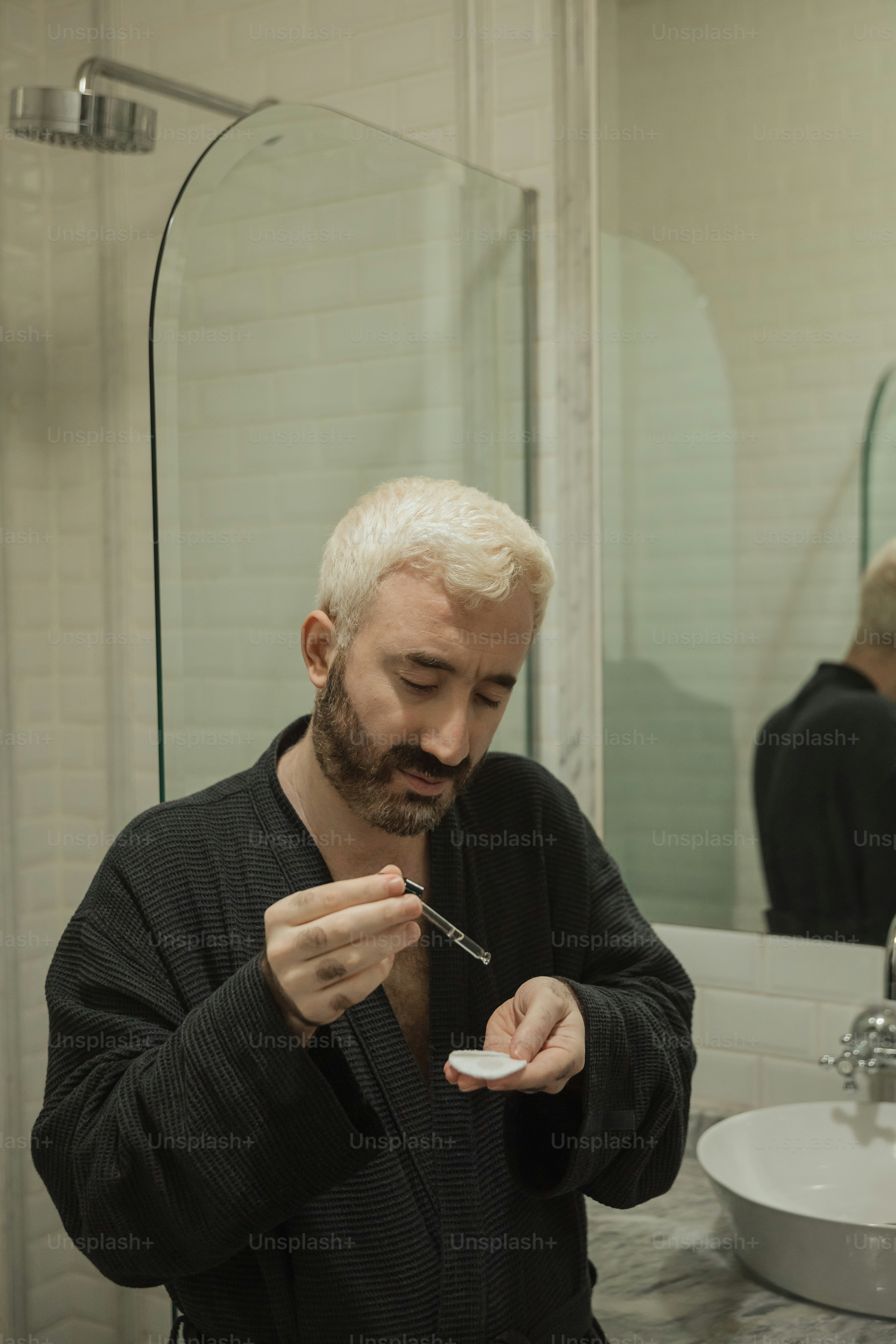 a man is brushing his teeth in the bathroom