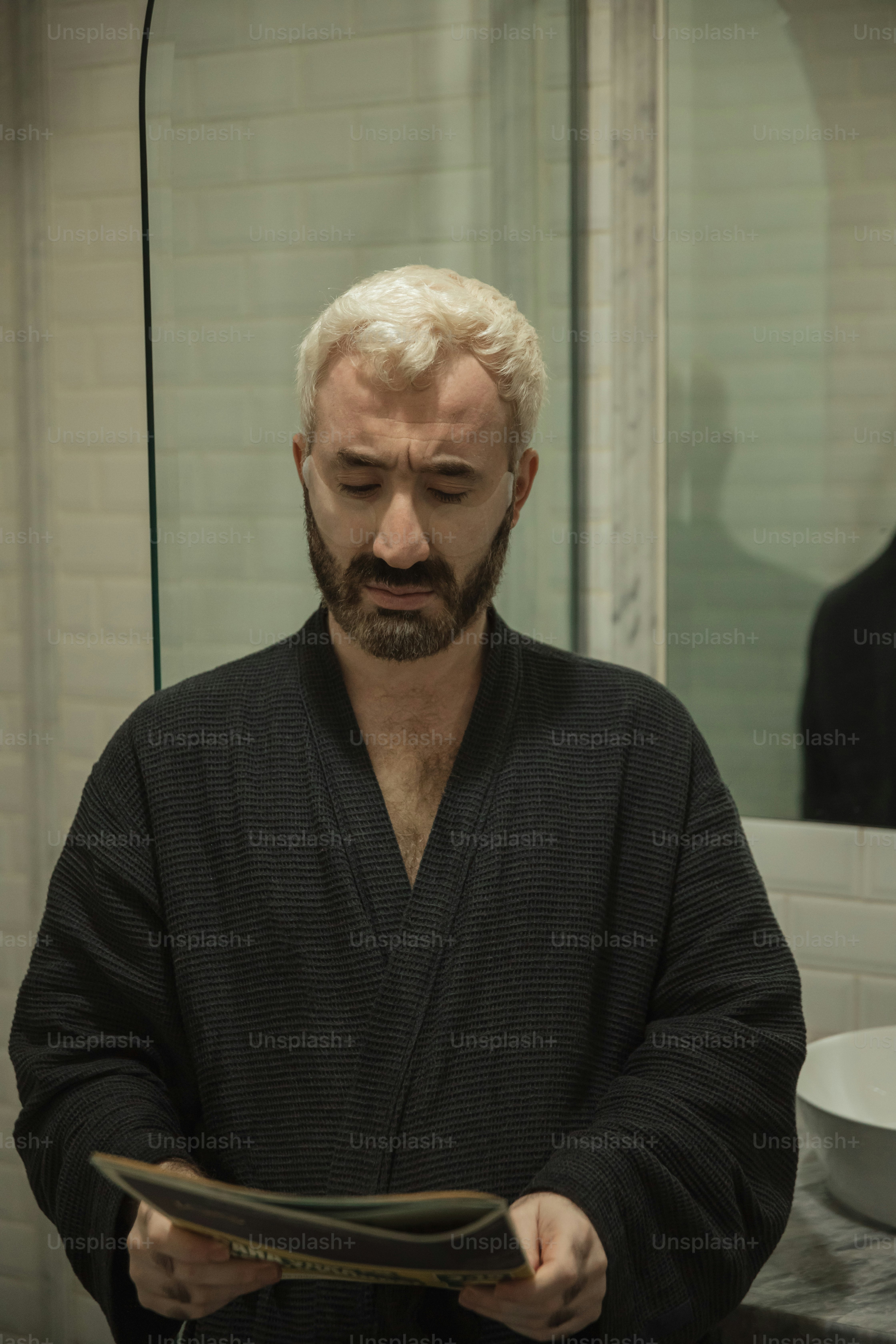 a man in a robe is looking at a piece of paper