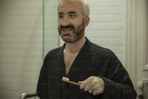 Ein Mann putzt sich im Badezimmer die Zähne