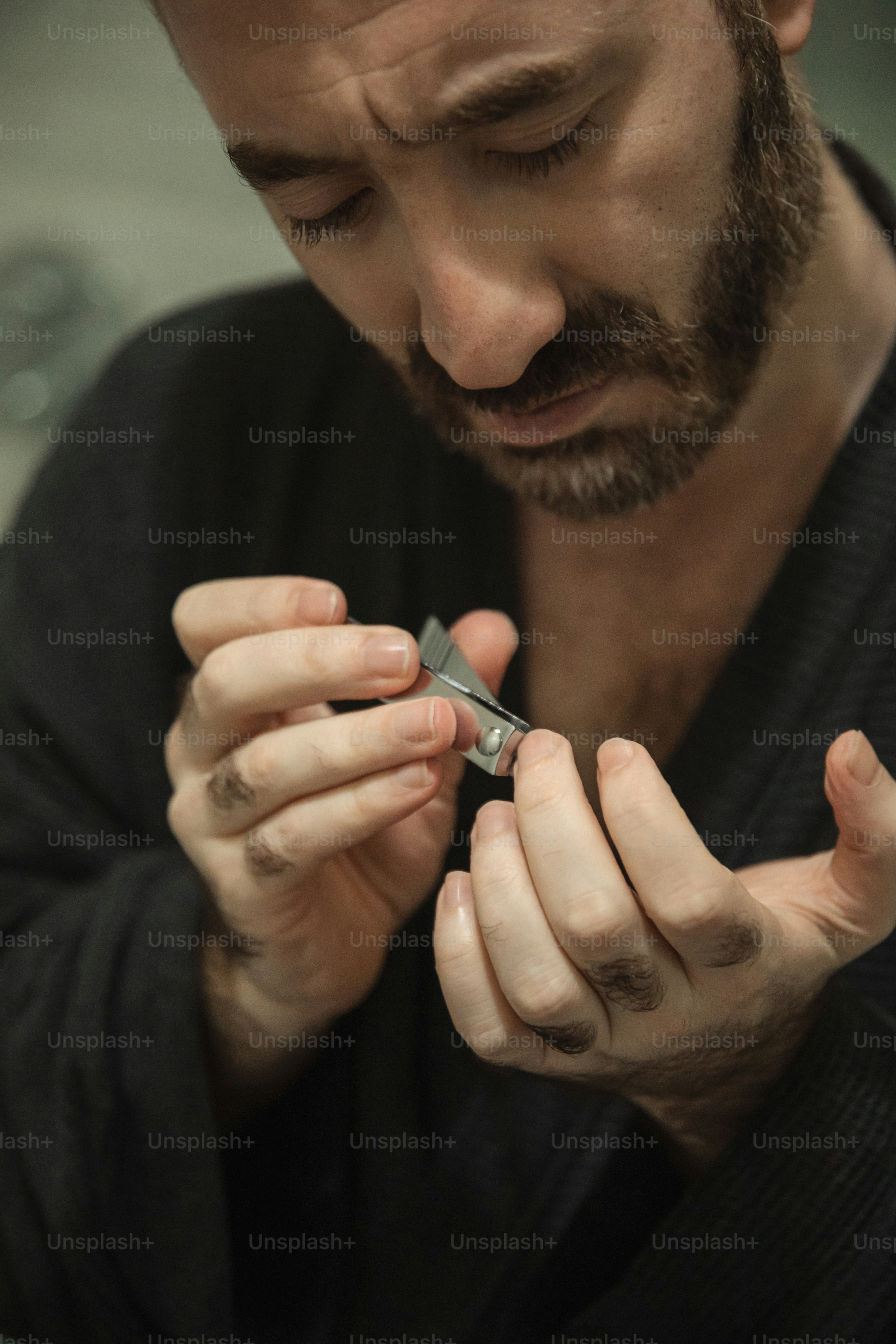 a man is holding a pair of scissors in his hands