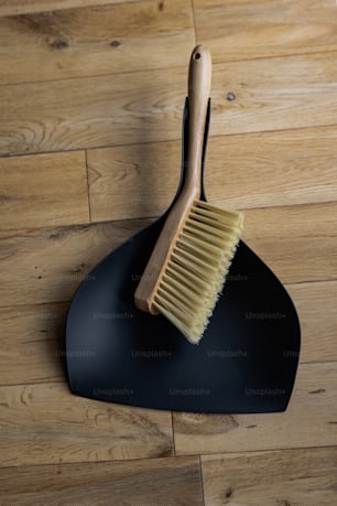 a wooden brush sitting on top of a black holder