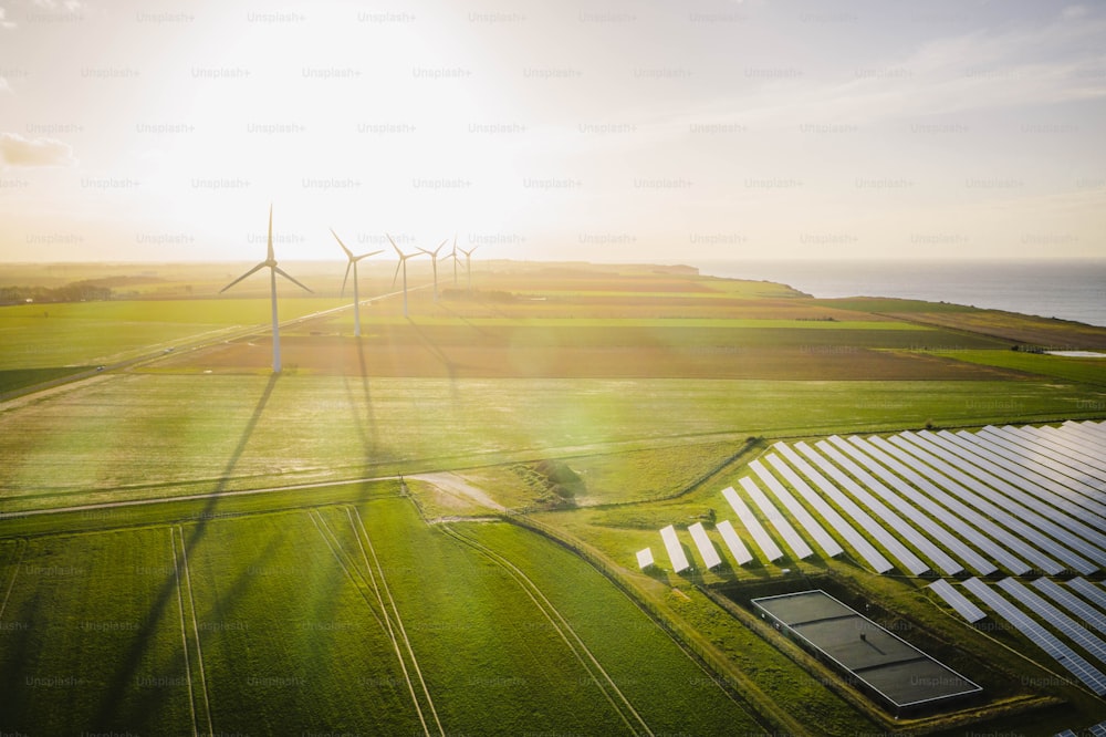 an aerial view of a wind farm near a body of water