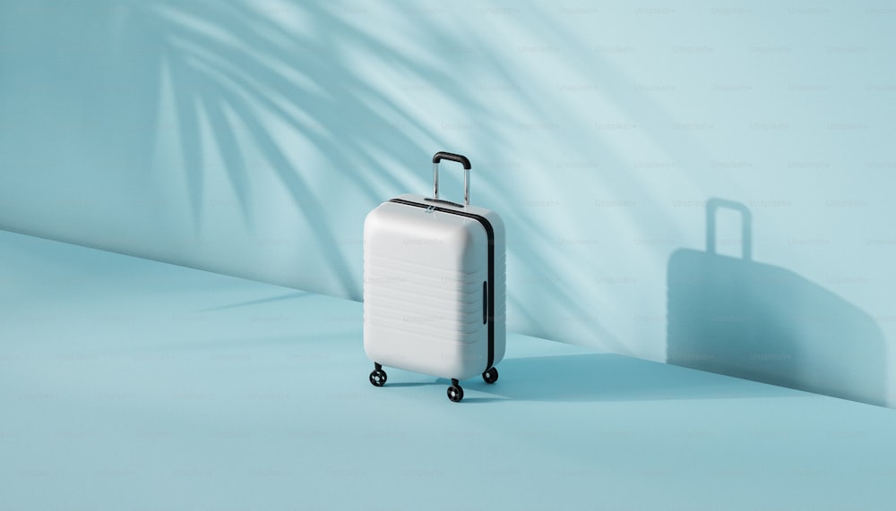 a white piece of luggage sitting on top of a blue floor