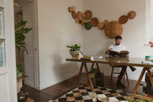 a man sitting at a table with a book