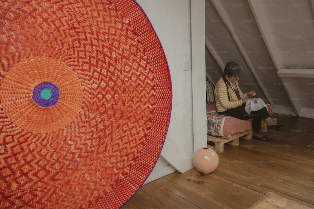 a person sitting on a bench in a room