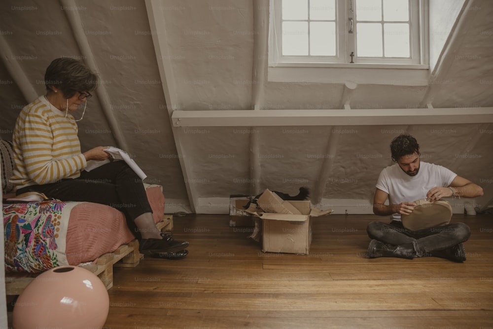 a man and a woman sitting on the floor