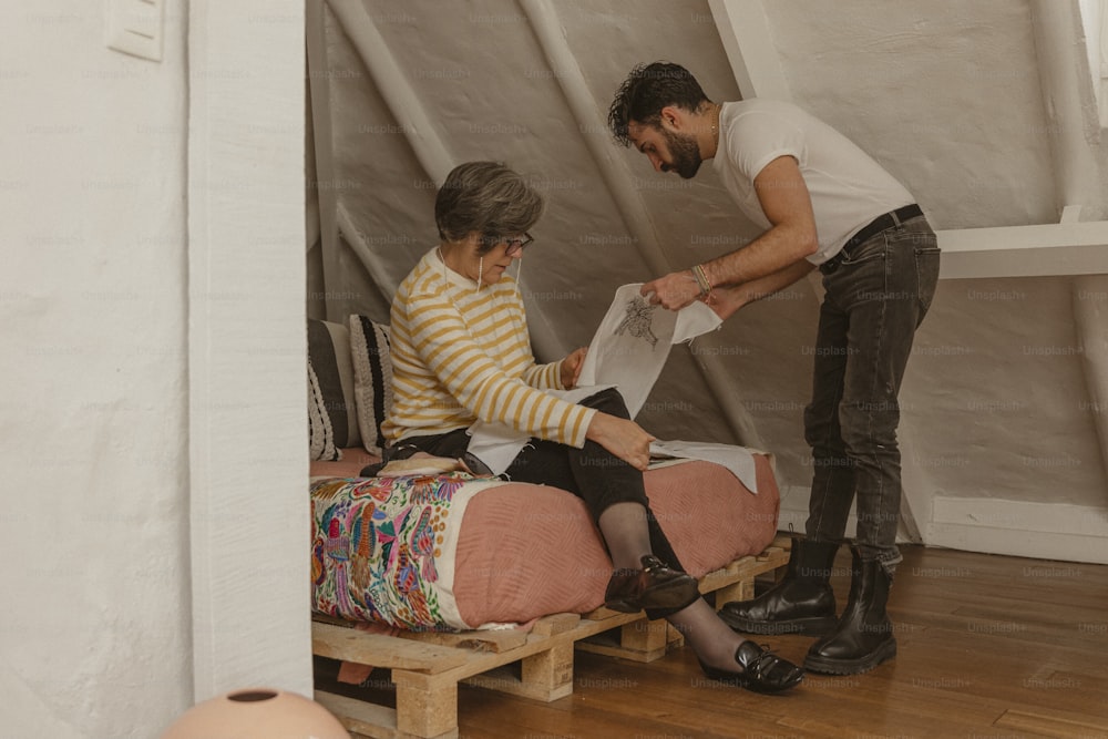 a man standing over a bed next to a woman